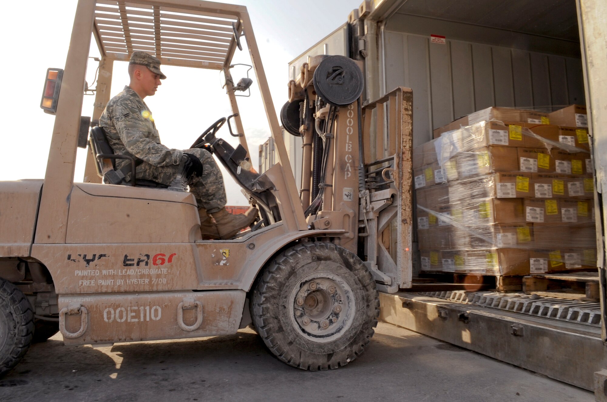 Airman 1st Class Denten Peasley, the storeroom manager for the 379th Force Support Squadron, loads pallets of food into a storage container here, Jan.12, 2009, in an undisclosed location. Pallets of food are brought into the base daily and must be seperated and stored for later meals. As the storeroom manager Airman Peasley must ensure all food products are accounted for on a daily basis. Airman Peasley's hometown is Oakland, Iowa and he is deployed from Dover Air Force Base, Del., in support of Operations Iraqi and Enduring Freedom and Joint Task Force-Horn of Africa.(U.S. Air Force Photo by Staff Sgt. Joshua Garcia/Released)