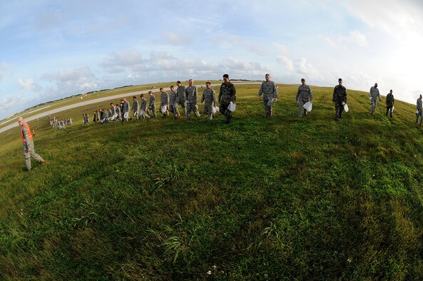 ANDERSEN AIR FORCE BASE, Guam - Members of Team Andersen participate in a mass FOD walk here Jan. 12 in preparation for the arrival of the F-22A Raptor.The F-22A is scheduled to arrive here as part of a three-month deployment in support of U.S. Pacific Command's security obligations in the Western Pacific. (U.S. Air Force photo by Senior Airman Nichelle Griffiths)   