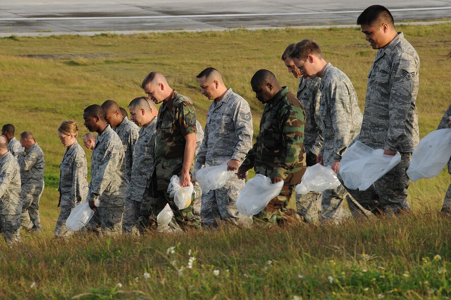 ANDERSEN AIR FORCE BASE, Guam - More than 700 members of Team Andersen participate in a mass FOD walk here Jan. 12 in preparation for the upcoming bomber and fighter deployment rotation.The goal of the FOD walk is to ensure all debris and foreign objects are cleared from the flightline. The F-22A Raptor and the B-2 Bomber are scheduled to return to Andersen. (U.S. Air Force photo by Senior Airman Nichelle Griffiths)   