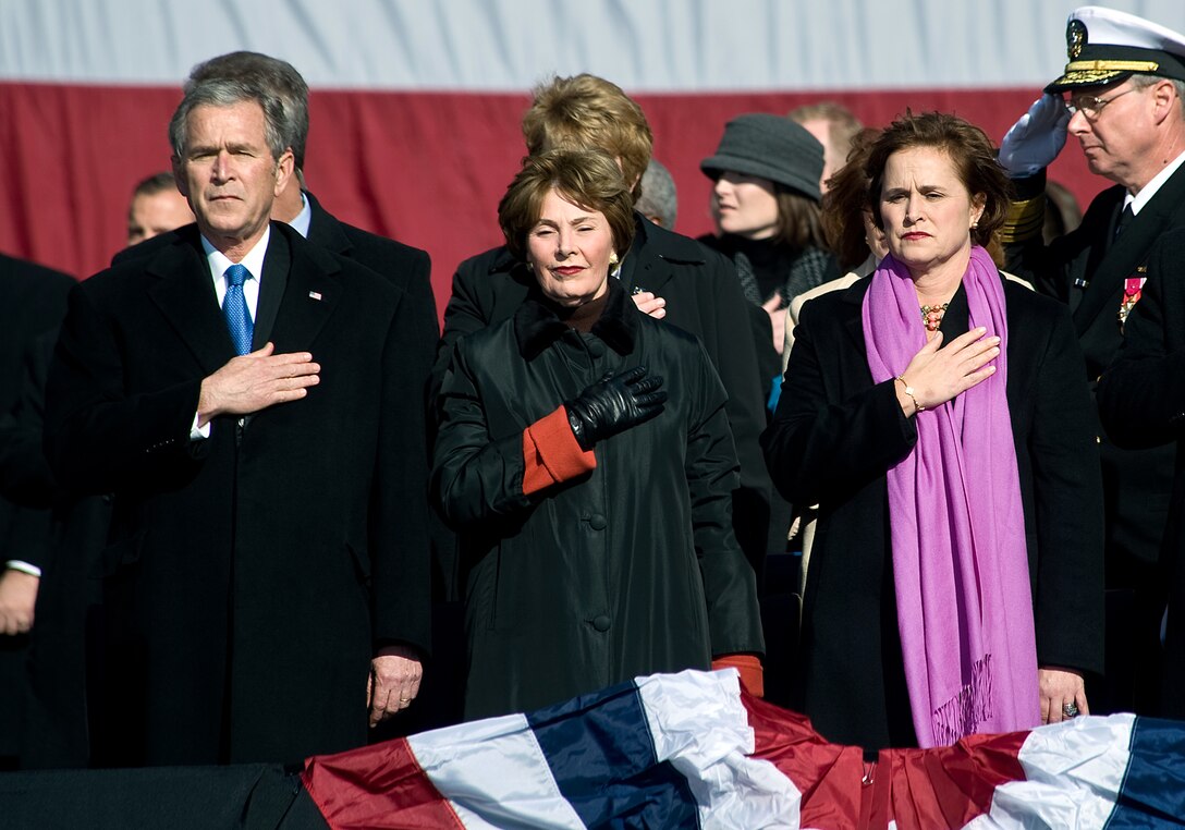 President George W. Bush, left, first lady Laura Bush, and the ship's sponsor, Dorothy Bush Koch, render honors during the national anthem at the start of the commissioning ceremony for the USS George H. W. Bush aircraft carrier at Naval Station, Norfolk, Va., Jan. 10, 2009.  