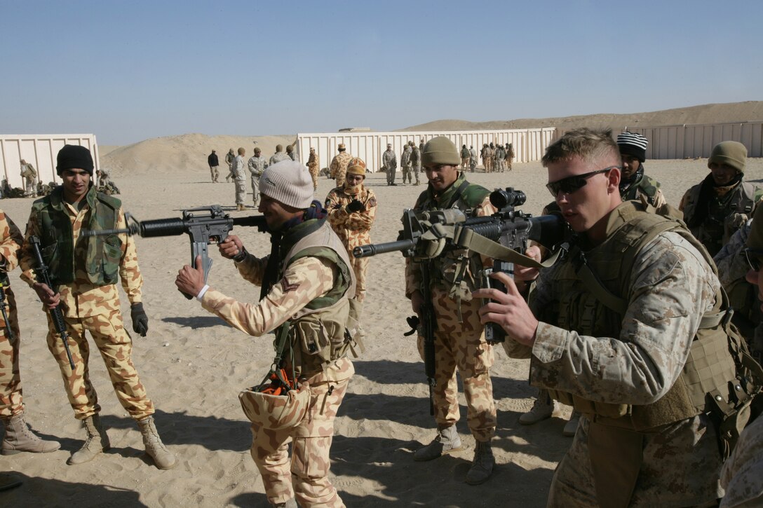 Marines from Echo Company, Battalion Landing Team 2/6, 26th Marine Expeditionary Unit, compete against Kuwaiti soldiers to see who can perform a speed reload faster, Jan. 13, 2009. The Marines were conducting the bilateral training to share their knowledge and to enhance combined and joint military relations. The 26th MEU is currently conducting sustainment training at Camp Buehring, Kuwait as part of its 2008-2009 deployment.