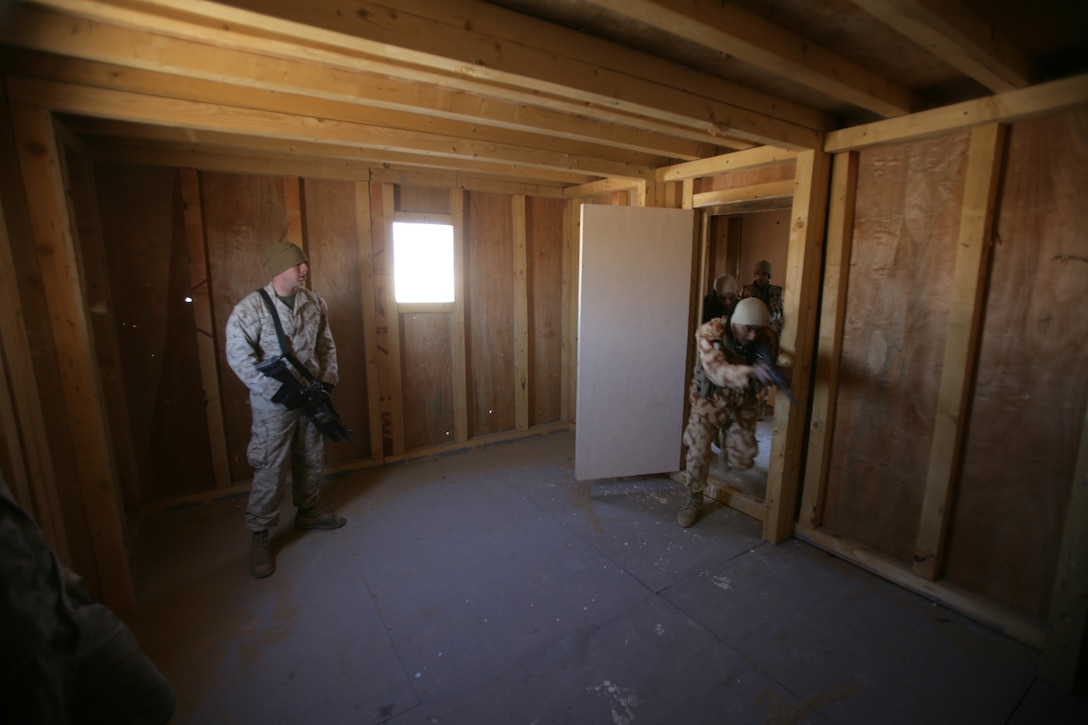 Marines from Echo Company, Battalion Landing Team 2/6, 26th Marine Expeditionary Unit, compete against Kuwaiti soldiers to see who can perform a speed reload faster, Jan. 13, 2009. The Marines were conducting the bilateral training to share their knowledge and to enhance combined and joint military relations. The 26th MEU is currently conducting sustainment training at Camp Buehring, Kuwait as part of its 2008-2009 deployment.