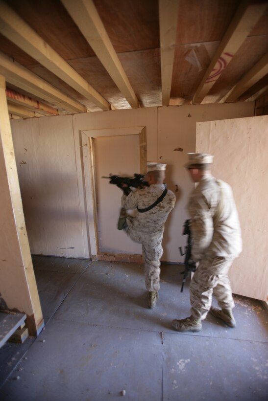 Marines from Echo Company, Battalion Landing Team 2/6, 26th Marine Expeditionary Unit, conduct house clearing drills, Jan. 13, 2009. The Marines were conducting the bilateral training to share their knowledge and to enhance combined and joint military relations. The 26th MEU is currently conducting sustainment training at Camp Buehring, Kuwait as part of its 2008-2009 deployment.