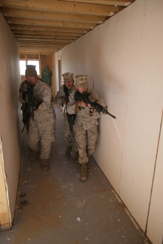 Marines from Echo Company, Battalion Landing Team 2/6, 26th Marine Expeditionary Unit, conduct house clearing drills, Jan. 13, 2009. The Marines were conducting the bilateral training to share their knowledge and to enhance combined and joint military relations. The 26th MEU is currently conducting sustainment training at Camp Buehring, Kuwait as part of its 2008-2009 deployment. (Official USMC photo by Cpl. Jason D. Mills) (Released)::r::::n::