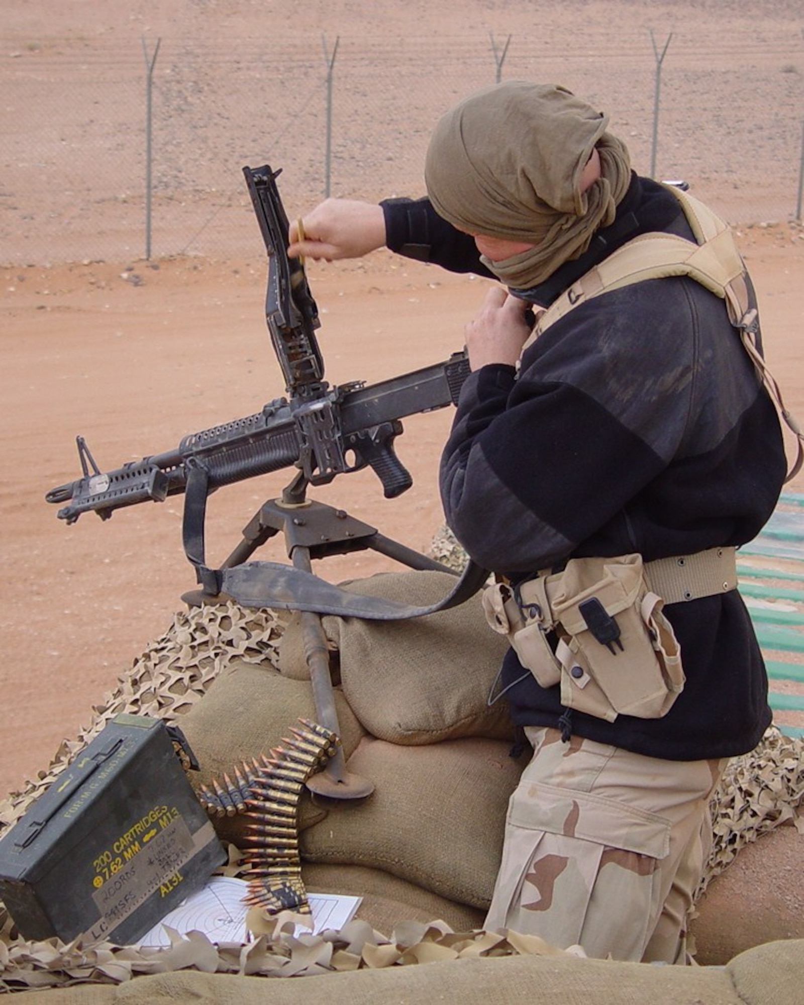A Security Forces member cleans the receiver of an M-60 machine gun just before conducting a function check. (U.S. Air Force photos courtesy of TSgt. Mario Reyes)