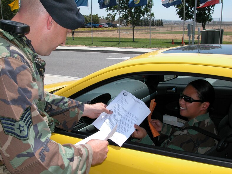 Staff Sgt. Ryan Collins, 452nd Security Forces Squadron, provides instructions to Staff Sgt. Bonnie Manglona, 452nd Maintenance Operations Squadron at the Main Gate at March ARB. She needed to know what the process was for getting a new CAC card. Security Forces members are accustomed to fielding a variety of questions at the base’s entry points. (U. S. Air Force photo by SSgt Joe Davidson)