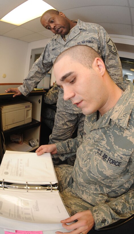 (Left) Master Sgt. Gregory Howell, Air Combat Command Logistics Standardization and Evaluation Team Vehicle Operations superintendant, observes as Senior Airman Thomas Smart, 28th Logistics Readiness Squadron operator record and license journeyman, looks through the suspended and revoked licenses binder, which maintains a record of suspended or revoked licenses here, Jan. 13. The LSET team examines maintenance, logistics and supply chain management performance, policies and procedures. (U.S. Air Force photo/Airman 1st Class Adam Grant)
