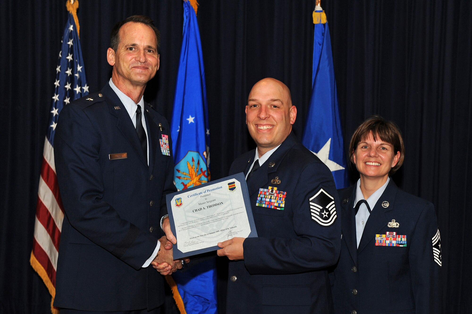 OFFUTT AIR FORCE BASE, Neb. ? Brig. Gen. James Jones, 55th Wing commander, and Chief Master Sgt. Lisa Sirois, 55th Wing command chief, congratulate newly promoted Master Sgt. Chad Thomson from the 55th Maintenance Operations Squadron , at a special promotion ceremony Jan. 9 at the Patriot Club. Through dedication and hard work, Sergeant Thomson and the 38 other promotees have earned their next stripe and have taken another step in their Air Force careers.