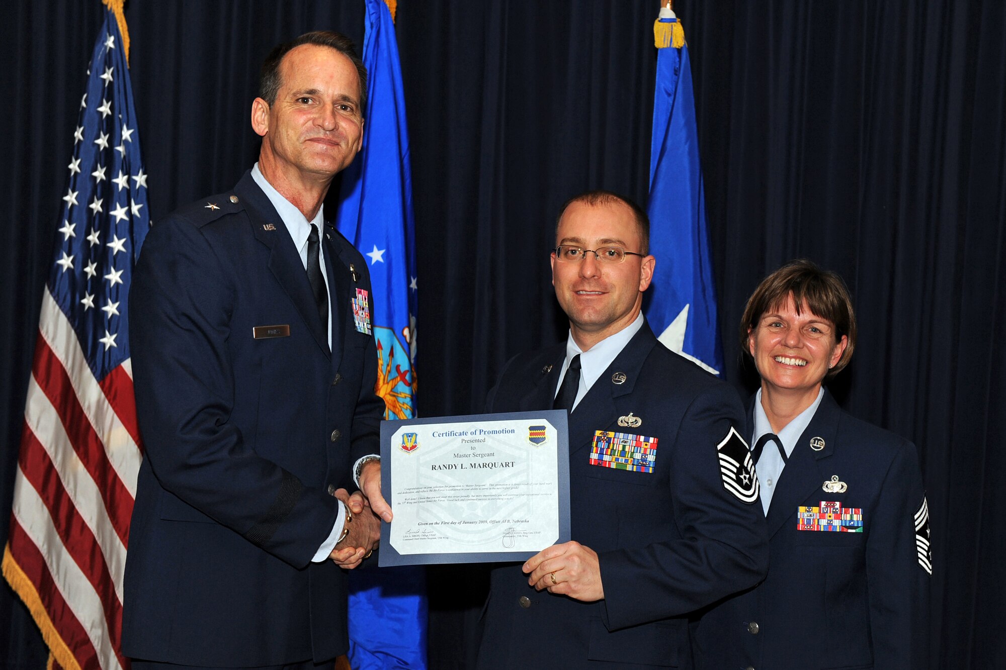 OFFUTT AIR FORCE BASE, Neb. ? Brig. Gen. James Jones, 55th Wing commander, and Chief Master Sgt. Lisa Sirois, 55th Wing command chief, congratulate newly promoted Master Sgt. Randy Marquart, 55th Force Support Squadron dining facility superintendent, at a special promotion ceremony Jan. 9 at the Patriot Club. Through dedication and hard work Sergeant Marquart and the other 38 promotees have earned their next stripe and have taken another step in their Air Force careers.