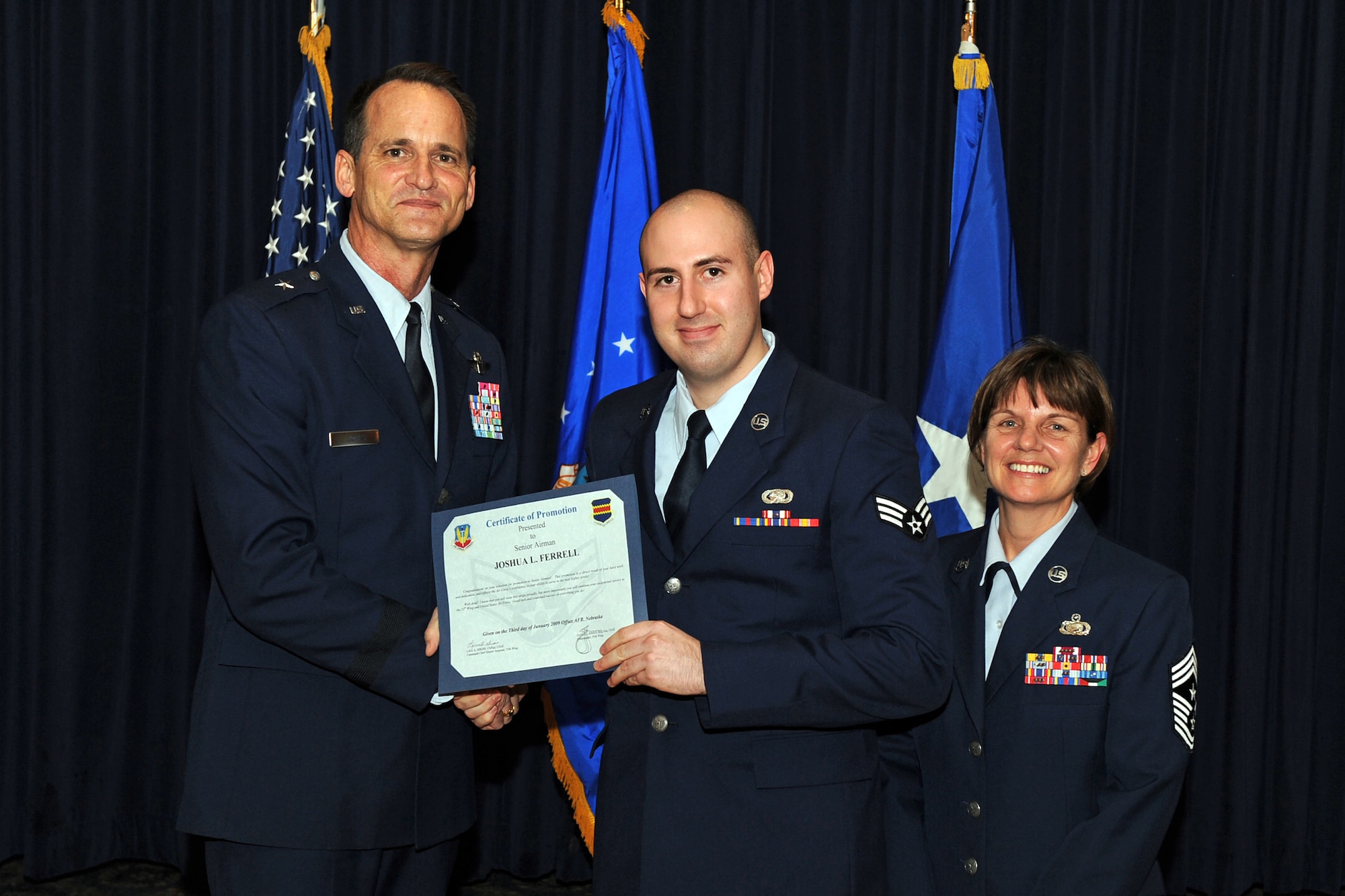 OFFUTT AIR FORCE BASE, Neb. ? Brig. Gen. James Jones, 55th Wing commander, and Chief Master Sgt. Lisa Sirois, 55th Wing command chief, congratulate newly promoted Senior Airman Joshua Ferrell, a 55th Mission Support Group logistics apprentice, at a special promotion ceremony Jan. 9 at the Patriot Club. Through dedication and hard work, Airman Ferrell and the 38 other promotees have erned their next stripe and have taken another step in their Air Force careers.
