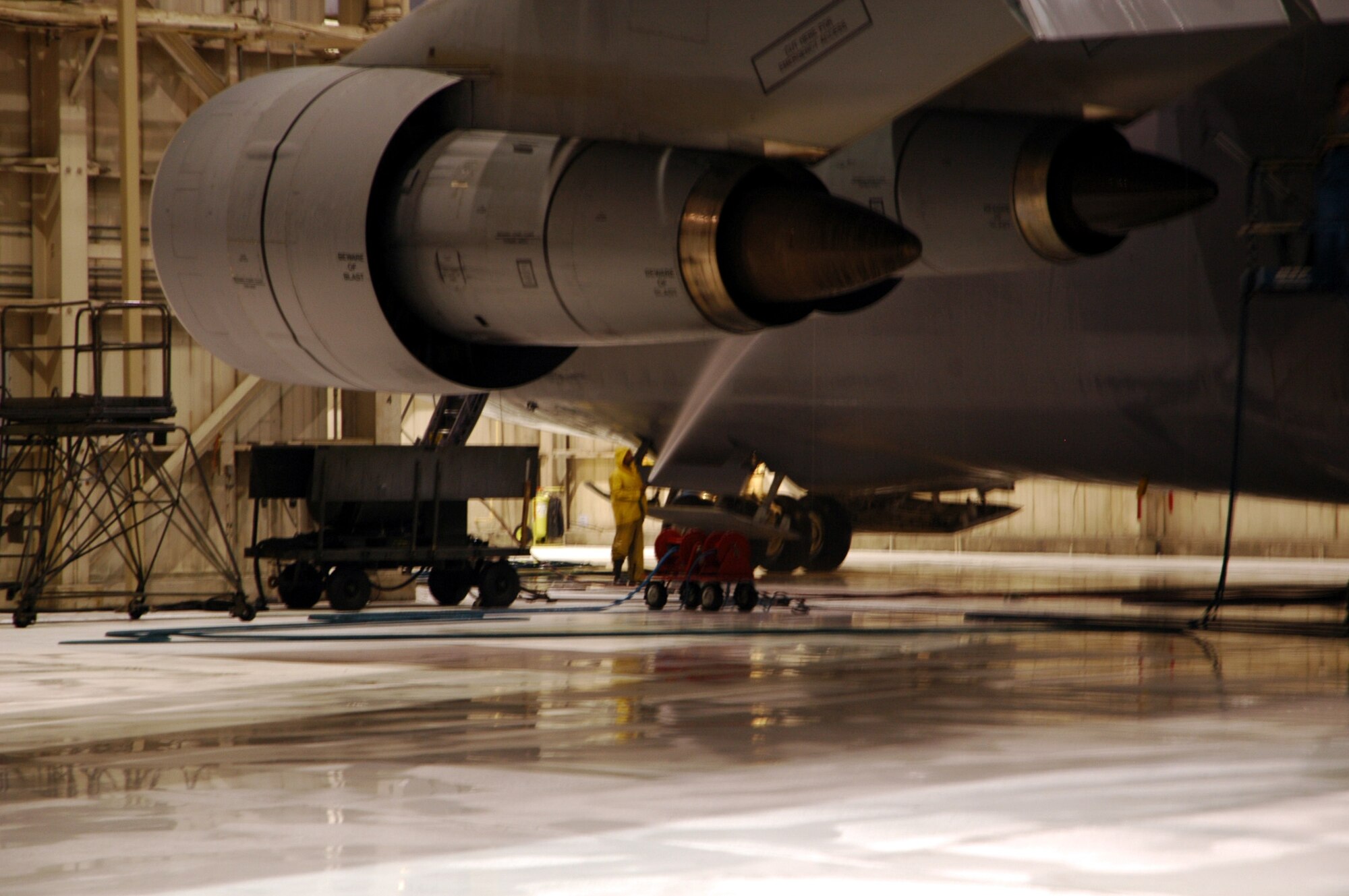 DOVER AFB, Del. - Mr. Elmer Smith  of Starlight Corp., rinses the landing gear door of a 445th Airlift Wing C-5 aircraft.  The C-5 takes a bath at Dover every 180 days and every inch of the plane is washed.  The wash process takes one full day and includes lubricating the flight controls, landing gear, and the cargo doors.  (Air Force photo/Senior Airman Andria Allmond)