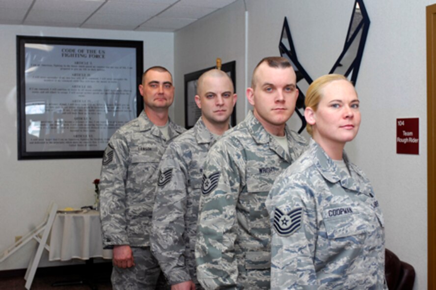 MINOT AIR FORCE BASE, N.D. -- (Front to back) Tech. Sgt. Julia Coopman, 5th Operations Group, Tech. Sgt. Aaron Wright, 5th Force Support Squadron, Tech. Sgt. James Rader, 91st Missile Wing, and Master Sgt. Ronnie Lawson, 5th Logistics Readiness Squadron, pose for a picture after being selected for promotion under the Stripes for Exceptional Performers (STEP) program here recently.   STEP promotions reward outstanding and deserving Airman who work hard and perform superbly. (U.S. Air Force photo by Staff Sgt. Keith Ballard)