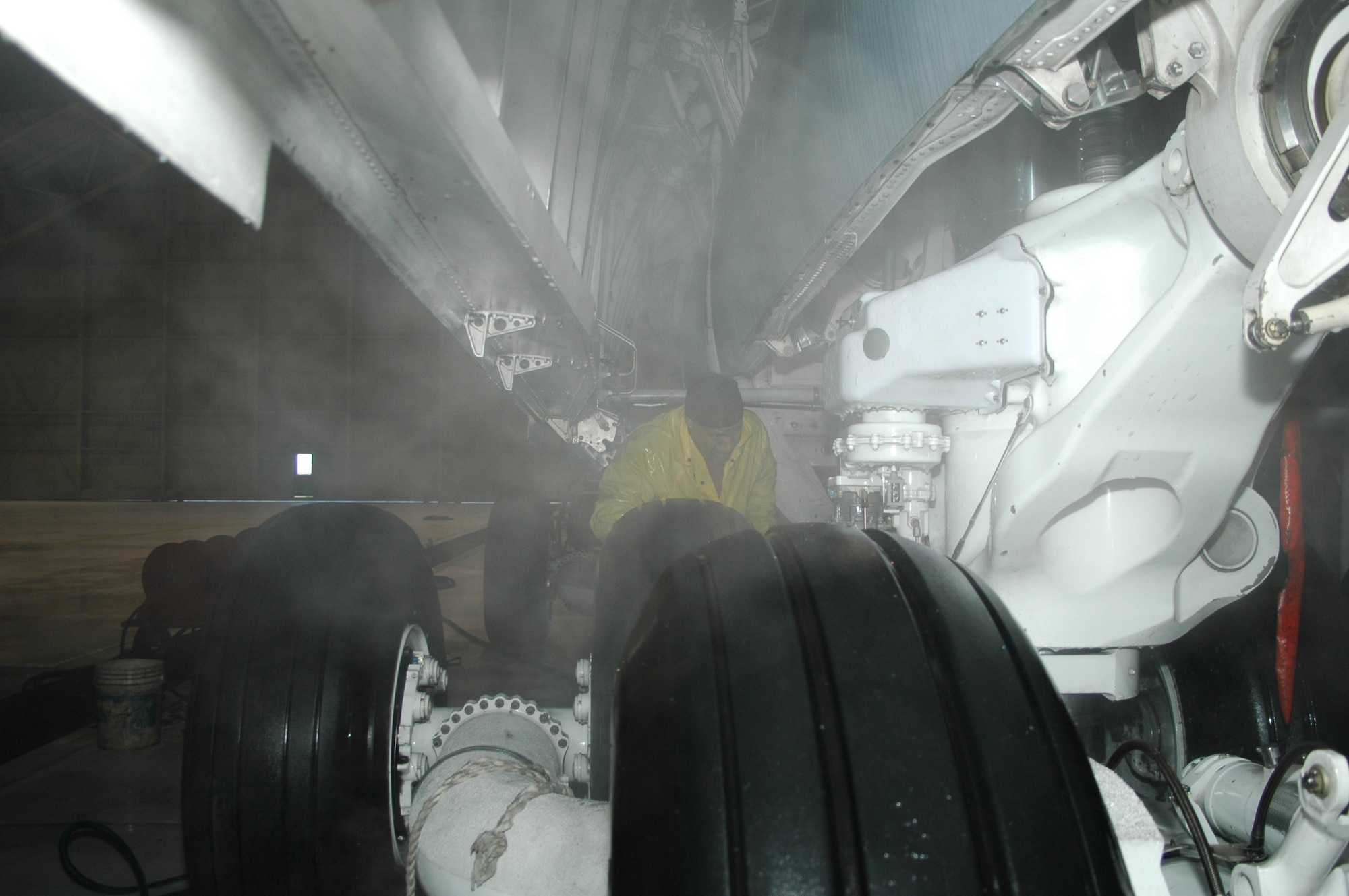 DOVER AFB, Del. - Mr. Ricky Flamer of Starlight Corp., washes the landing gear of a 445th Airlift Wing C-5 aircraft.  The C-5 takes a bath at Dover every 180 days and every inch of the plane is washed.  The wash process takes one full day and includes lubricating the flight controls, landing gear, and the cargo doors.  (Air Force photo/Senior Airman Andria Allmond)