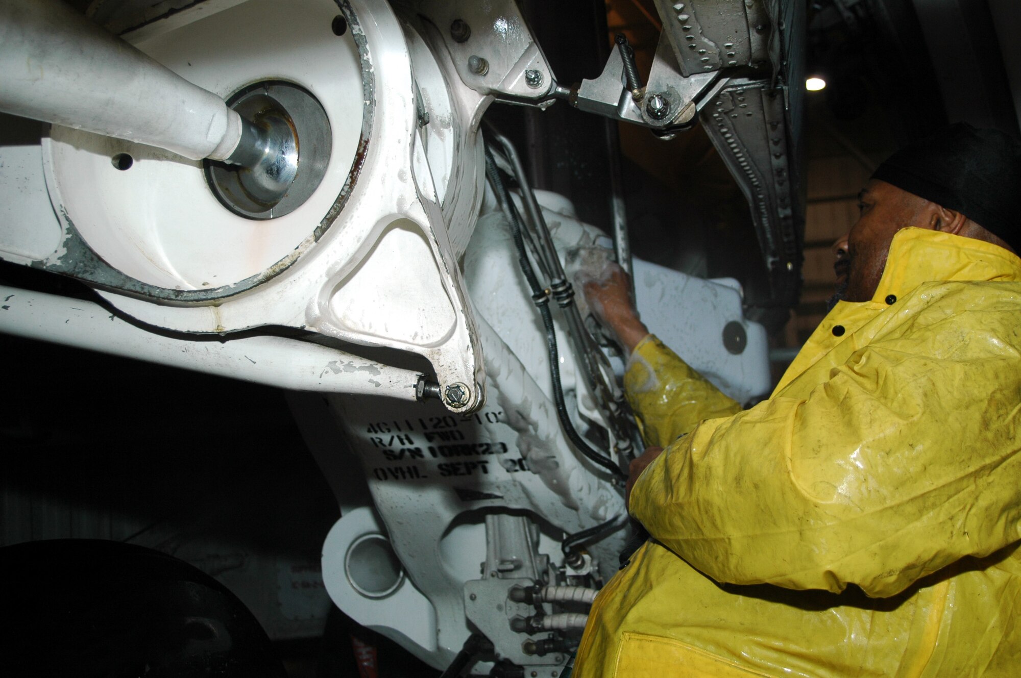 DOVER AFB, Del. - Mr. Ricky Flamer of Starlight Corp., washes the landing gear of a 445th Airlift Wing C-5 aircraft.  The C-5 takes a bath at Dover every 180 days and every inch of the plane is washed.  The wash process takes one full day and includes lubricating the flight controls, landing gear, and the cargo doors.  (Air Force photo/Senior Airman Andria Allmond)