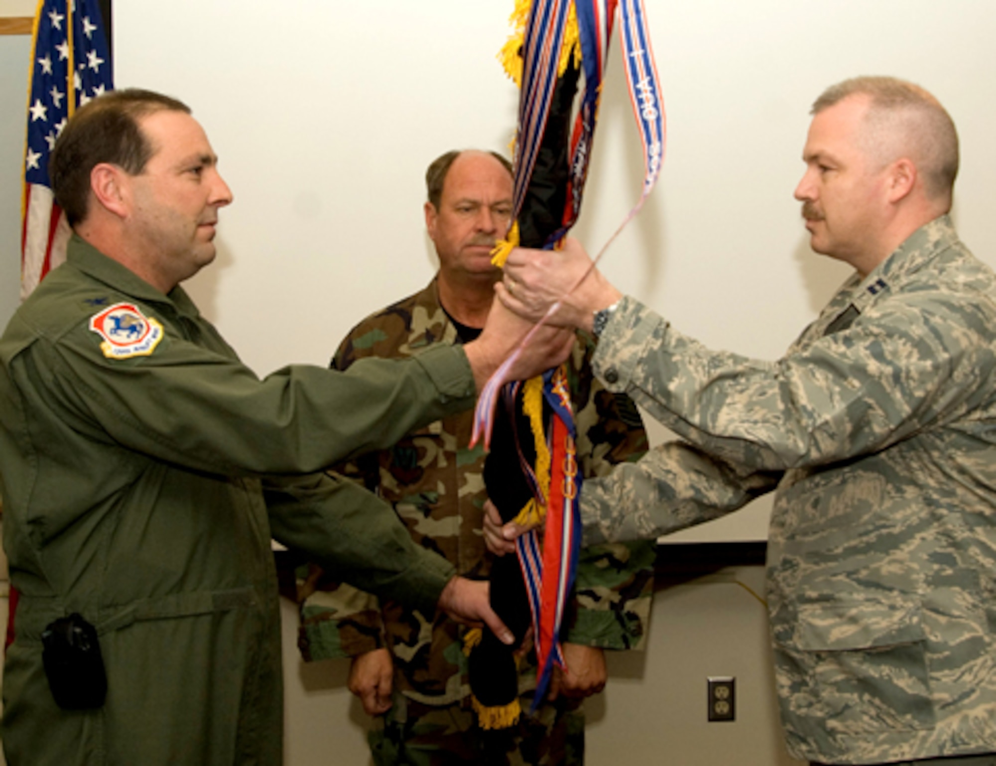 Captain John Howie accepts command of the 241st Air Traffic Control Squadron from Colonel Ralph Schwader, 139th Airlift Wing, 180th Group Commander, at Rosecrans Airport on January 10, 2009. (U.S. Air Force photo by Tech. Sgt. Shannon Bond) (RELEASED)
