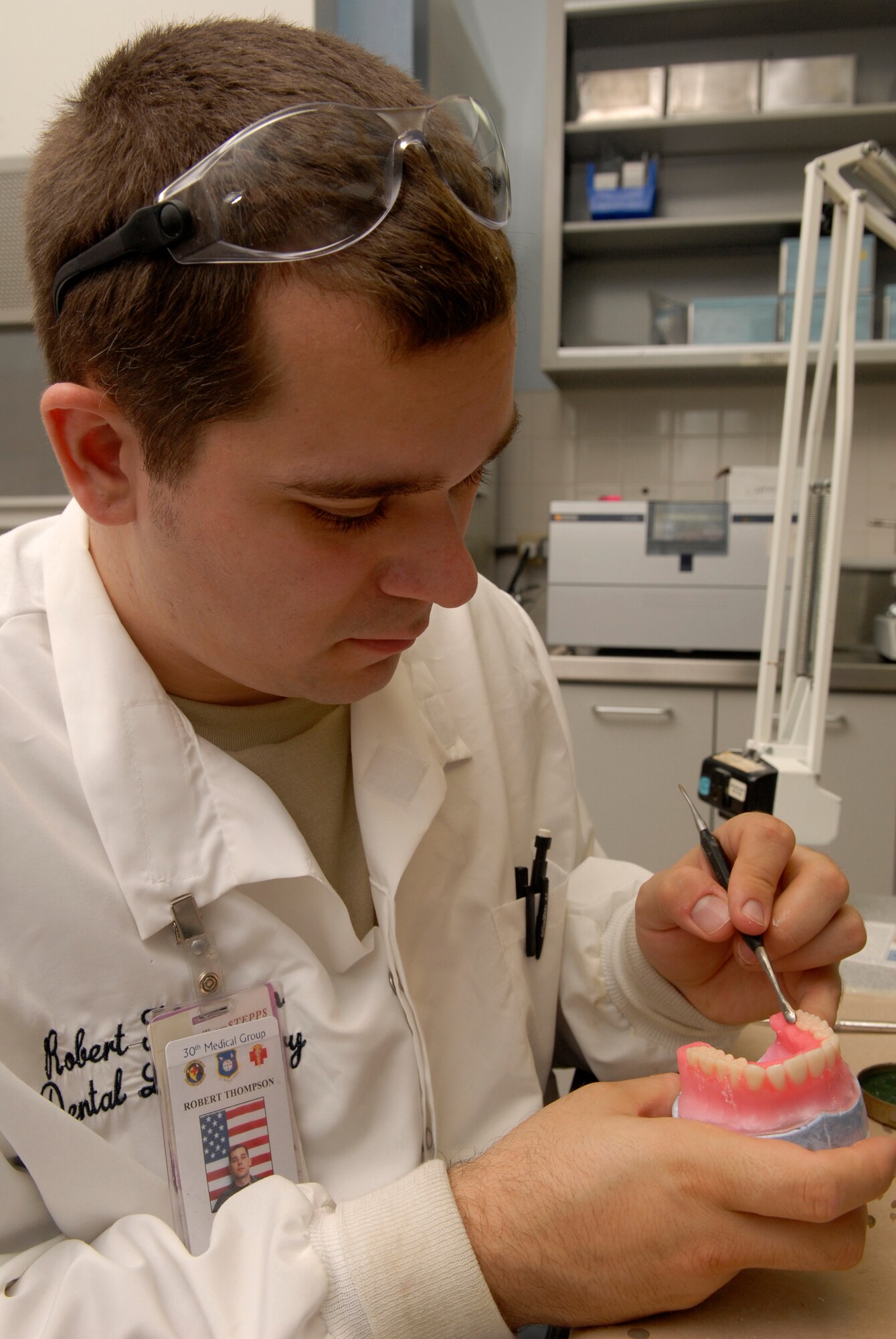 VANDENBERG AIR FORCE BASE, Calif. -- Airman 1st Class Robert Thompson, a dental lab technician with the 30th Medical Operations Squadron, carves anatomy into dentures on Jan. 8. Whether it's blood pressure checks or dental work, staying fit to fight is every Airman's responsibility. (U.S. Air Force photo/Senior Airman Christian Thomas) 