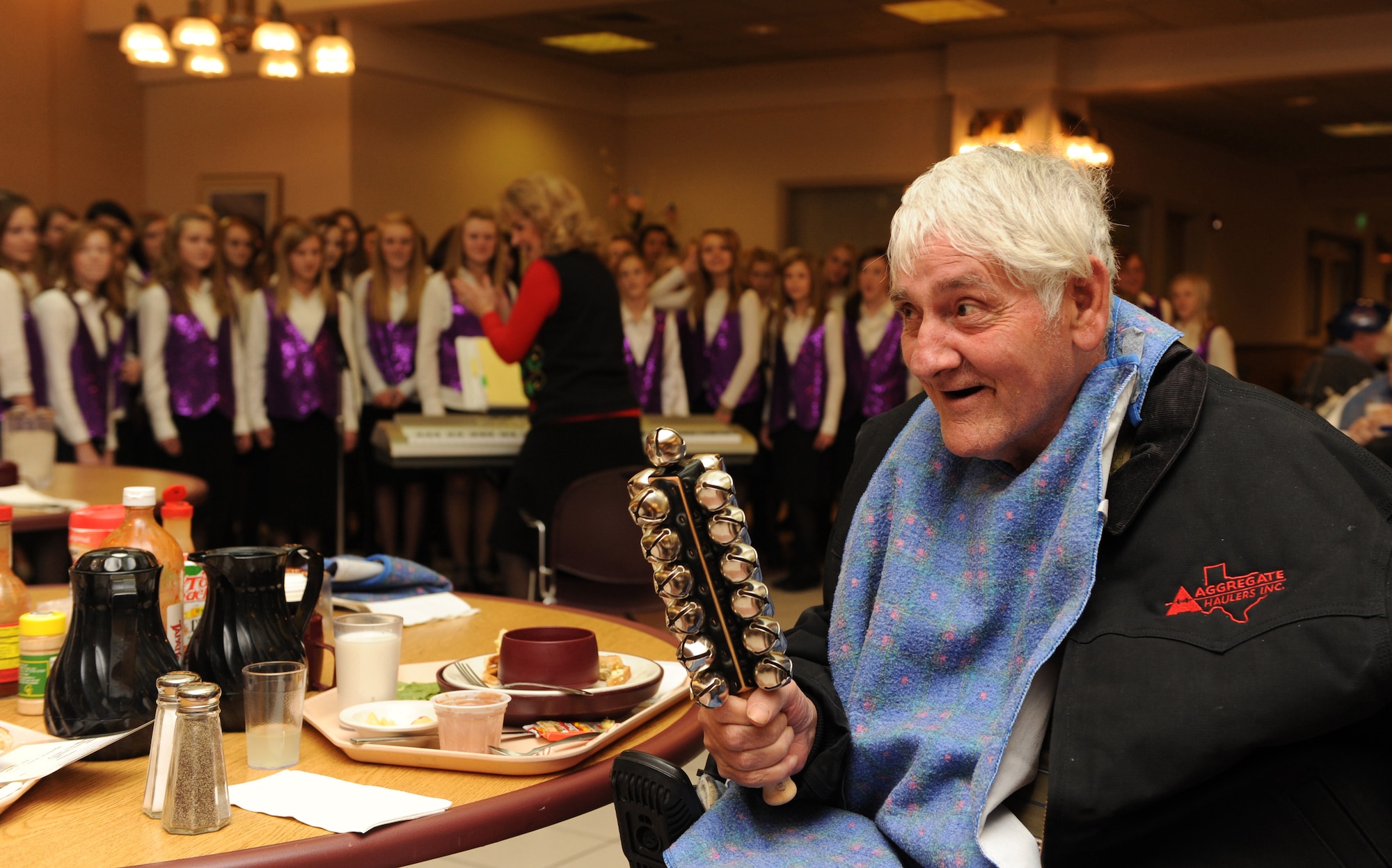 MOUNTAIN HOME AIR FORCE BASE, Idaho -- Veteran Ron Dashiell keeps the beat of jingle bells as the seventh grade girls choir from Eagle Middle School, in Eagle, Idaho, sings at Idaho State Veteran's Home in Boise, Idaho, Dec. 16. The choir volunteered their time to sing for the veterans as Airman from the group Airman for American Veterans of Mountain Home Air Force Base played bingo and served lunch. (U.S. Air Force photo/ Airman 1st Class Debbie Lockhart)