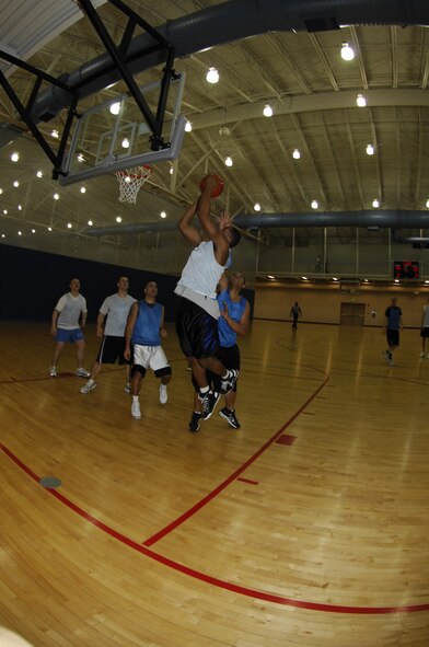 MINOT AIR FORCE BASE, N.D. -- Airman 1st Class Victor Calcote, a member of the 91st Operations Group intramural basketball team,  drives to the hoop during the 2008-09 Intramural Basketball Championship game held at the McAdoo Fitness Center here Jan. 12.  The 91st OG took home the championship after defeating the 91st Maintenance Group 49-28. (U.S. Air Force photo by Tech. Sgt. Lee A. Osberry Jr.)