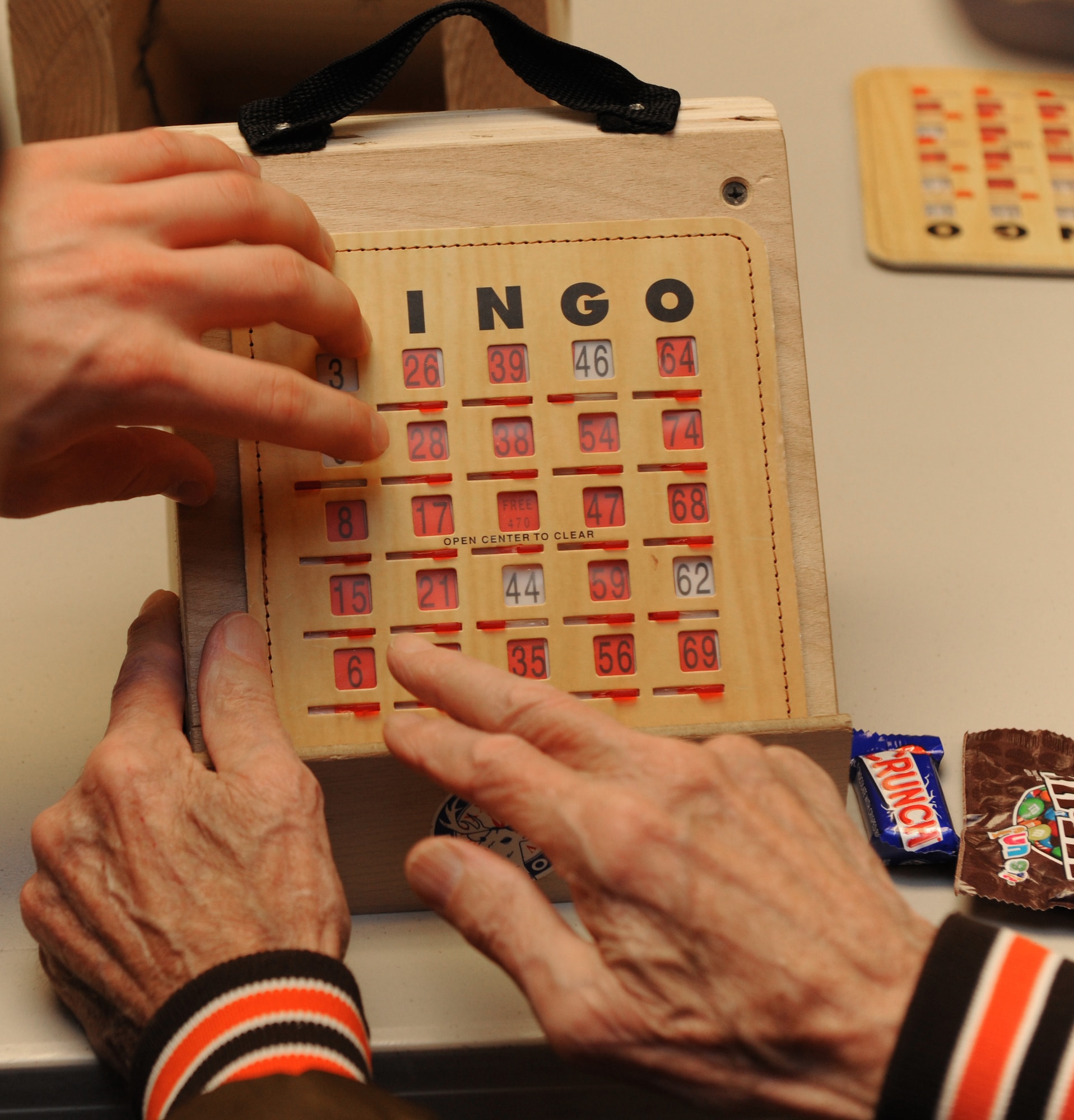MOUNTAIN HOME AIR FORCE BASE, Idaho -- Senior Airman Paul Pleiman, 366th Logistics Readiness Squadron vehicle operator, plays bingo with veteran Chuck Puntney at the Idaho State Veteran's Home Dec. 16. Airmen from Mountain Home Air Force Base traveled to the Idaho State Veteran’s Home in Boise for a holiday visit. The group, Airmen for American Veterans, began the day inviting veterans to bingo, after which they helped serve lunch. (U.S. Air Force photo/ Airman 1st Class Debbie Lockhart)
