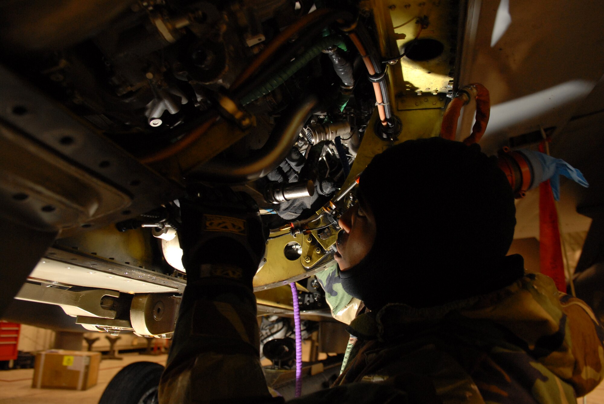 Senior Airman Mark Robinson 80th Aircraft Maintenance Unit replaces a control unit on an F-16 during the Peninsula-Wide Operational Readiness Exercise Beverly Bulldog 09-01 at Kunsan Air Base, Republic of Korea, Jan. 13, 2009. The unit controls all the engine settings of the F-16 acting as its "brain". (U.S. Air Force Photo by Senior Airman Angela Ruiz)  