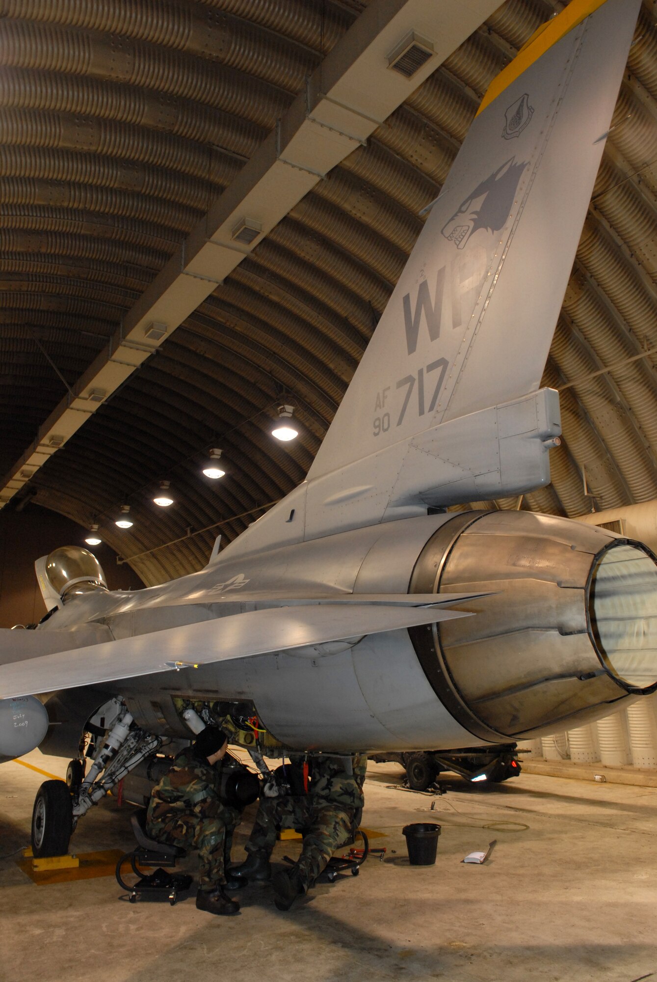 Staff Sgt. Clint Cloonan, 80th Aircraft Maintenance Unit works inside a Hardened Aircraft Shelter with Senior Airman Mark Robinson 80th AMU to remove and replace the Digital Electronic Control of a F-16 during the Peninsula-Wide Operational Readiness Exercise Beverly Bulldog 09-01 at Kunsan Air Base, Republic of Korea, Jan. 13, 2009. The Airmen work inside a HAS to protect them and the aircraft from enemy fire in order to complete the maintenance quickly and safely. (U.S. Air Force Photo by Senior Airman Angela Ruiz)  