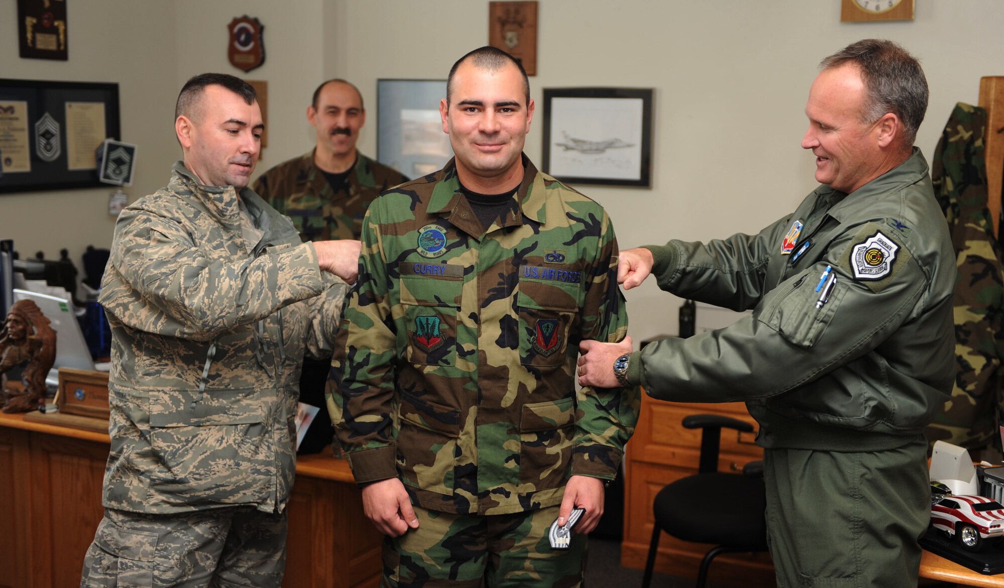 MOUNTAIN HOME AIR FORCE BASE, Idaho -- Tech. Sgt. James Curry, 366th Aircraft Maintenance Squadron, receives a Stripe for Exceptional Performance, or STEP promotion, from Col. James Browne, 366th Fighter Wing commander and Chief Master Sgt. Ronald McCarthy, 366th Fighter Wing command chief Dec. 31. The STEP program, established in 1982, is designed to allow commanders to promote Airmen who meet unique or exceptional circumstances. (U.S. Air Force photo/ Senior Airman Ryan Crane)