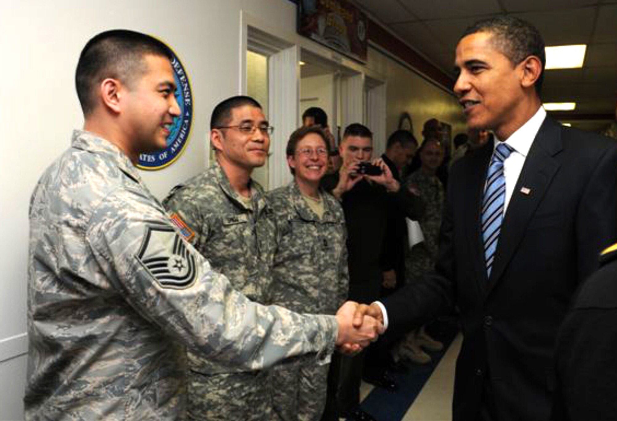 Master Sgt.  James Ting greets President-elect Barak Obama during a visit at the Inauguration Committee work center at Washington,  D.C.,  Jan. 8.  Team Charleston Airmen have deployed to help the committee plan the inauguration for the new commander in chief.  Sergeant Ting is a contracting advisor with the inauguration committee and is currently deployed from the 437th Contracting Squadron.