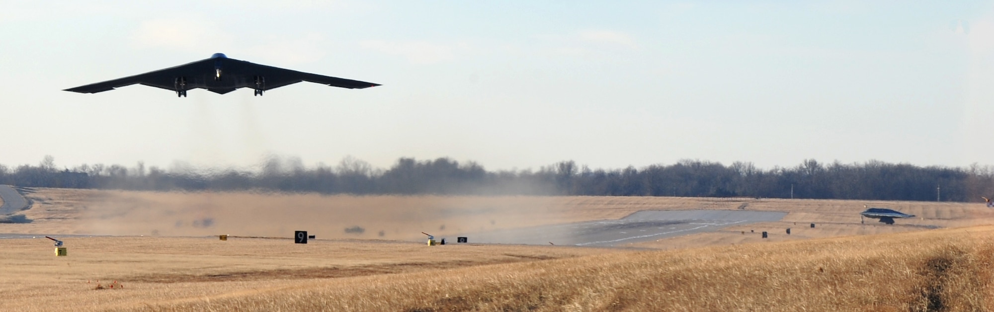 WHITEMAN AIR FORCE BASE, Mo. - A B-2 bomber takes off early morning Jan. 13, while another B-2 is waits at the other end of the runway. The multiple aircraft fly off is part of the 509th Bomb Wing's first Nuclear Operational Readiness Exercise of 2009. (U.S. Air Force photo/Airman 1st Class Carlin Leslie)