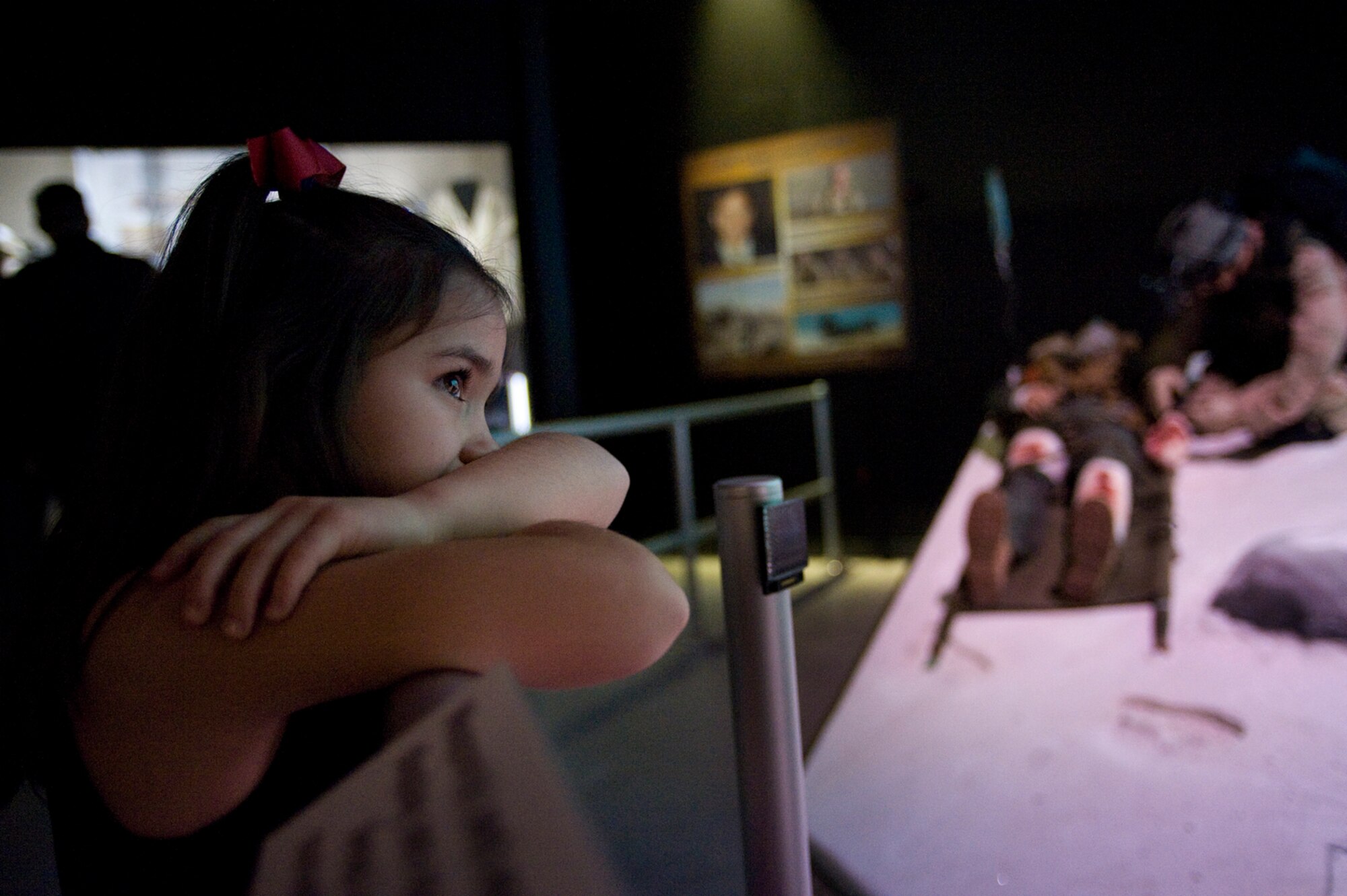 Kearsten Miller, 7, watches a interactive video showcasing her father, Master Sgt. Keary Miller during the opening of the Warrior Airmen Exhibit Jan. 12 at the National Museum of the U.S. Air Force at Wright-Patterson Air Force Base, Ohio. Sergeant Miller is a pararescuman who fought during the Battle of Takur Ghar, the deadliest entanglement of Operation Anaconda in Afghanistan. (U.S. Air Force photo/Staff Sgt. Bennie J. Davis III)