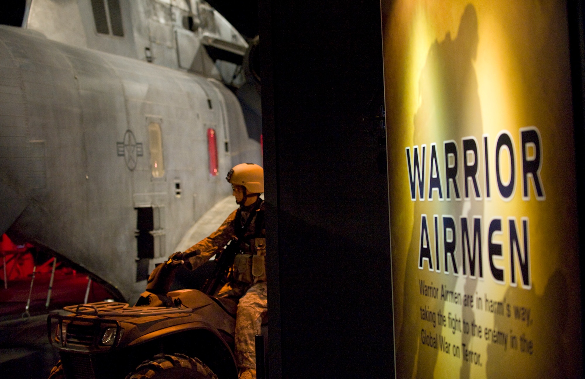 A MH-53 Pave Low helicopter along with special operations equipment and detailed mannequins showcase donated items of Airmen who served in the war on terrorism Jan. 12 at the Warrior Airmen Exhibit of the National Museum of the U.S. Air Force at Wright-Patterson Air Force Base, Ohio. (U.S. Air Force photo/Staff Sgt. Bennie J. Davis III)