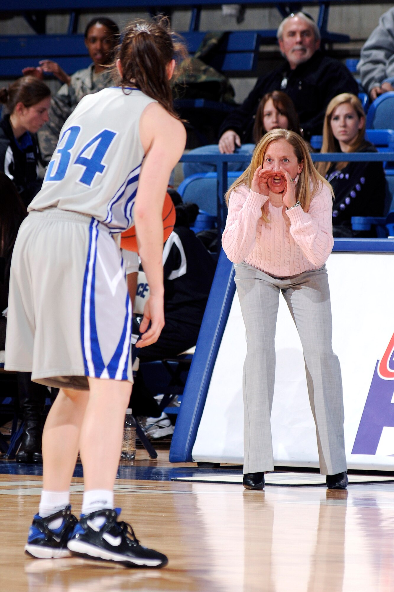 U.S. Air Force Academy women's head coach Ardie McInelly yells directions to senior Brooke Cultra during the 73-39 loss against the New Mexico Lobos Jan. 9 at the Academy in Colorado. Cultra added nine points and nine rebounds, along with two blocked shots. The Falcons return to action Jan. 14 at Utah. (U.S. Air Force photo/Mike Kaplan)
