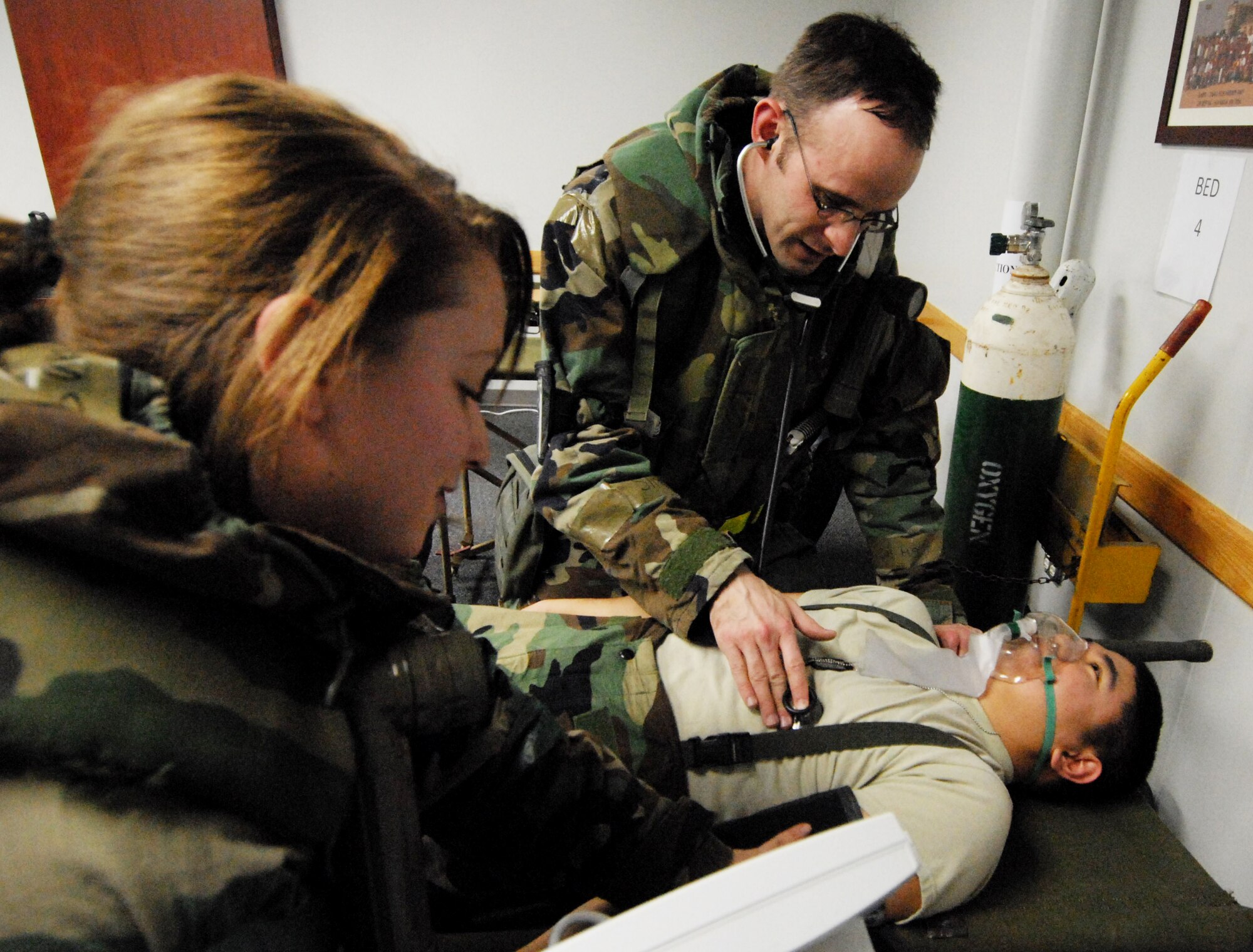 Airman 1st Class Sarah Hudak and Capt. Kevin Baldovich, 8th medical Group, check the vital signs of a patient during the Peninsula-Wide Operational Readiness Exercise at Kunsan Air Base, Republic of Korea, Jan. 14, 2009. The patient was brought in after experiencing shortness of breath. (U.S. Air Force Photo by Senior Airman Gustavo Gonzalez) 