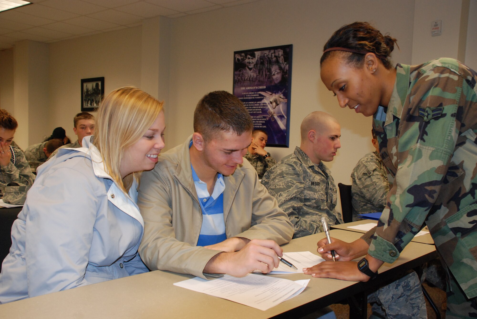 Airman 1st Class Porsha Smith, 82nd MSS evaluations manager, helps Airman 1st Class Jason Carter, a 362nd Training Squadron Airman in Training, and his wife Kaitlyn, fill out a form at Sheppard's Marriage Day. The MSS helped more than 130 newlyweds fill out the proper paperwork to begin benefits and other entitlements for spouses. (U.S. Air Force photo/Mike McKito)