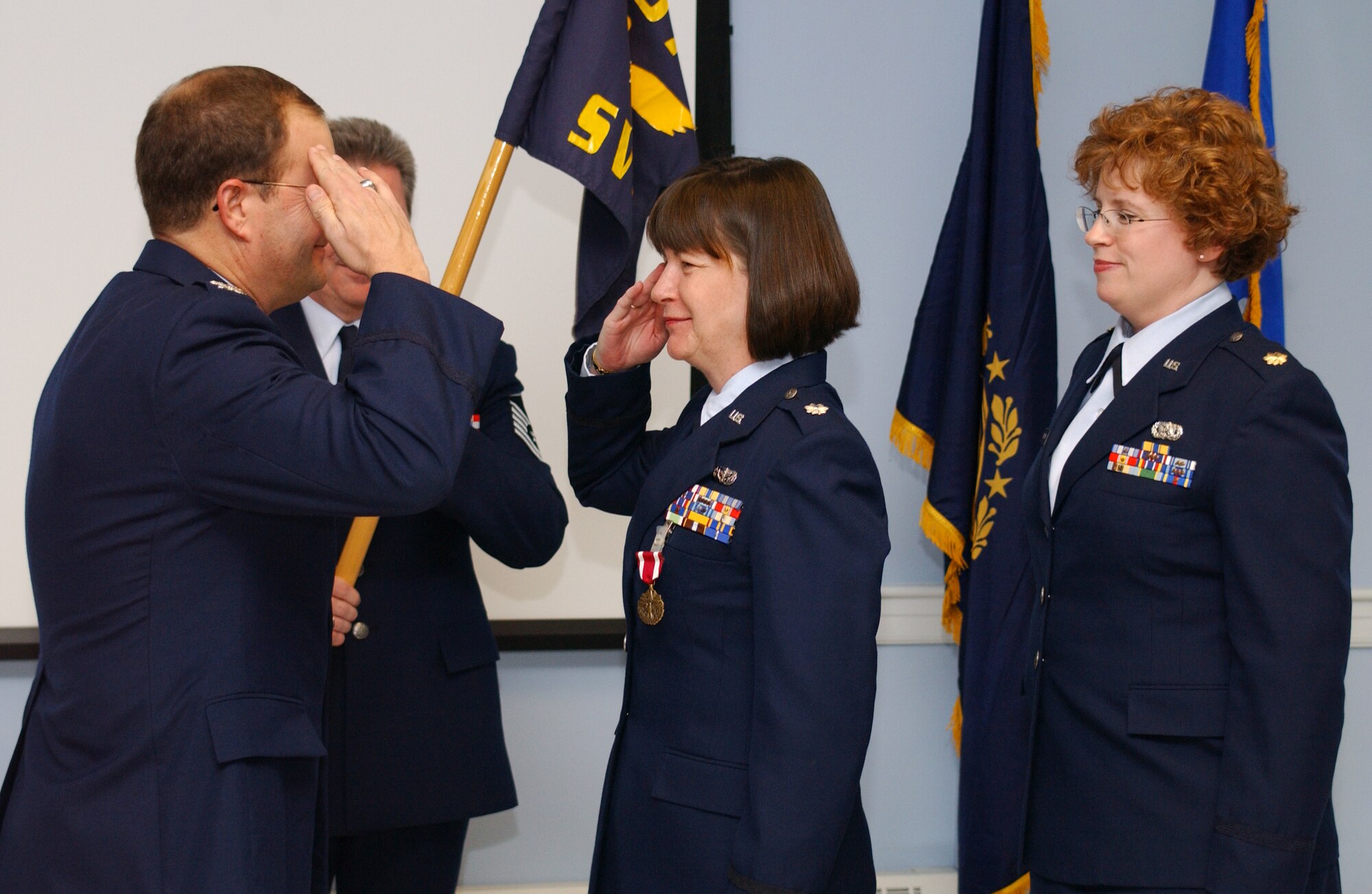 Lieutenant Colonel Laurie McAvoy renders a salute to the 157th Air Refueling Wing Mission Support Group Commander, Colonel Dutch Dunkelberger, before turning over command of the 157th Services Flight to Major Jennifer Haggard.  (U.S. Air Force photo/Technical Sgt. Mark E. Wyatt)