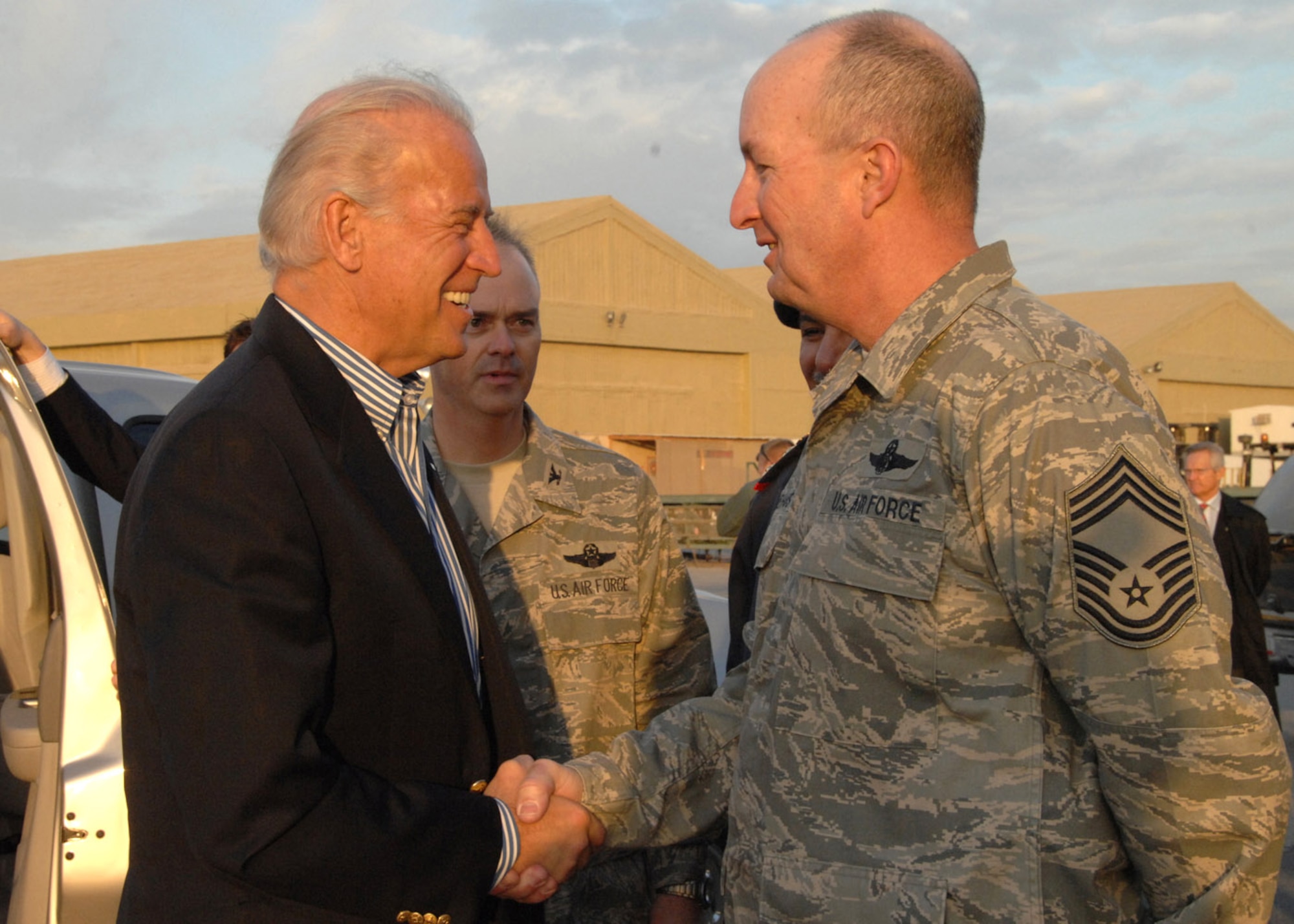 Vice President-elect Joe Biden shakes hands with Chief Master Sgt. Dave Niehaus Jan. 12 at an air base in Southwest Asia. Vice President-elect Biden is headed into Iraq as part of his trip to the region. Chief Niehaus is the 387th Expeditionary Group superintendent. (U.S. Air Force photo/Senior Airman Courtney Richardson) 
