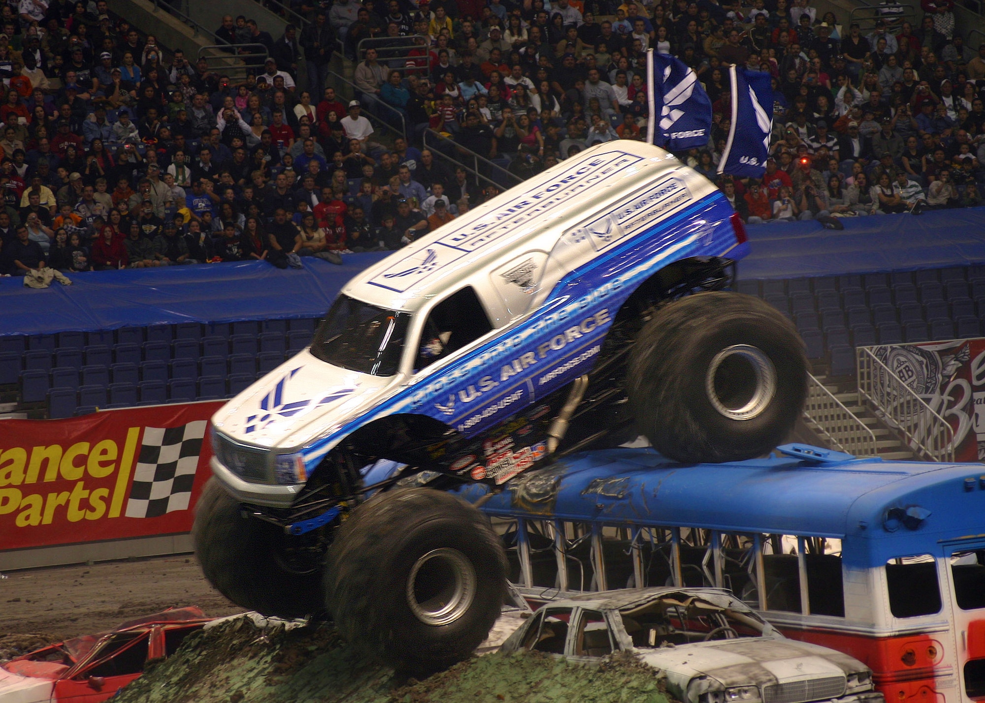 The Air Force Afterburner monster truck, driven by Damon Bradshaw, maneuvers over a bus during the 2009 Monster Jam freestyle competition Jan. 10 at San Antonio?s Alamodome. (U.S. Air Force photo/Dale Eckroth) 
 
