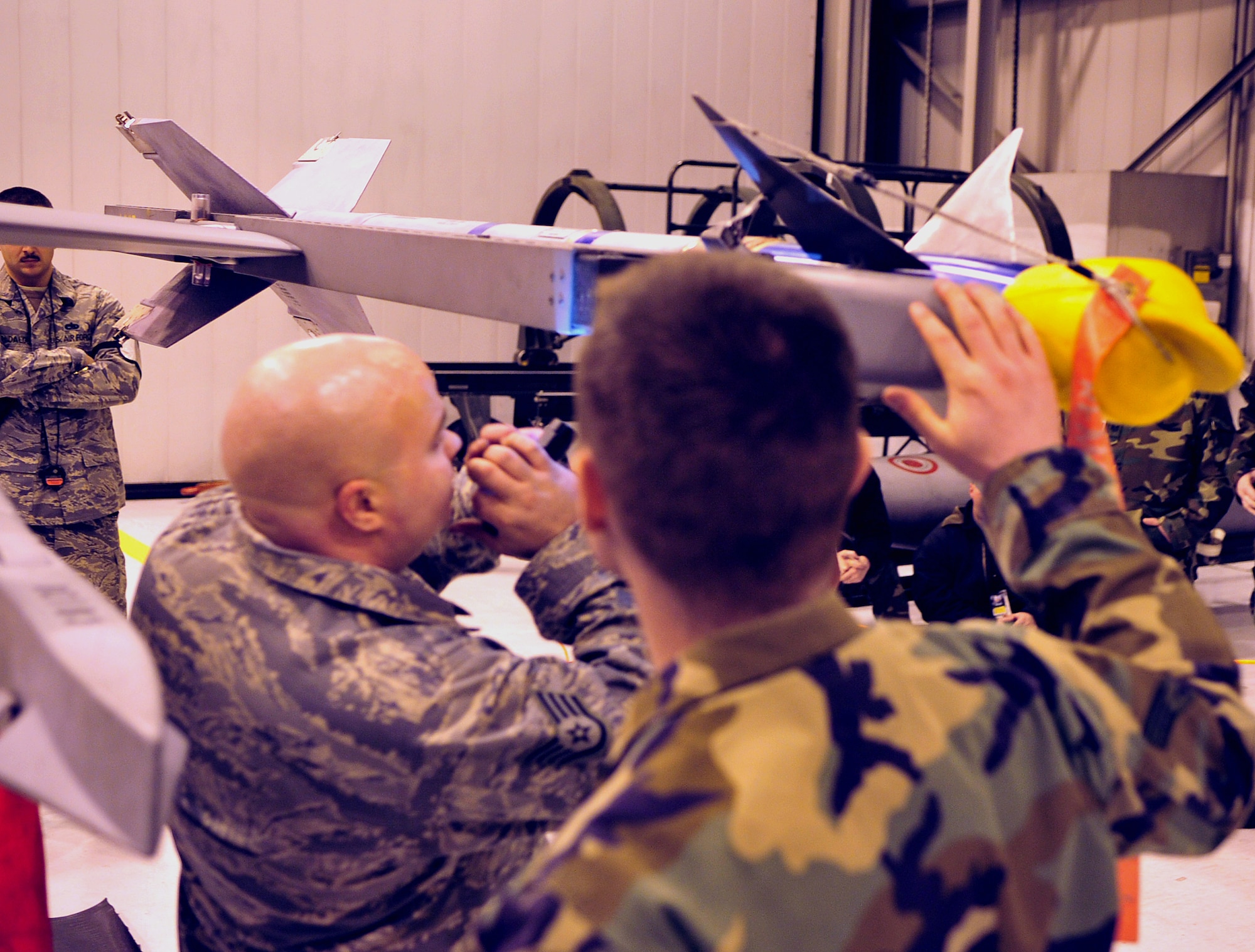 Staff Sgt. Matthew Fratzke, Weapons Load Team Chief, and Senior Airman Billy Peacock, 354th Aircraft Maintenance Squadron, make final checks to an AIM-9L/M Sidewinder Missile during a load competition. The competition employs safety and the accuracy at which the assigned technical orders are followed. (U.S. Air Force photo/Airman 1st Class Willard E. Grande II)