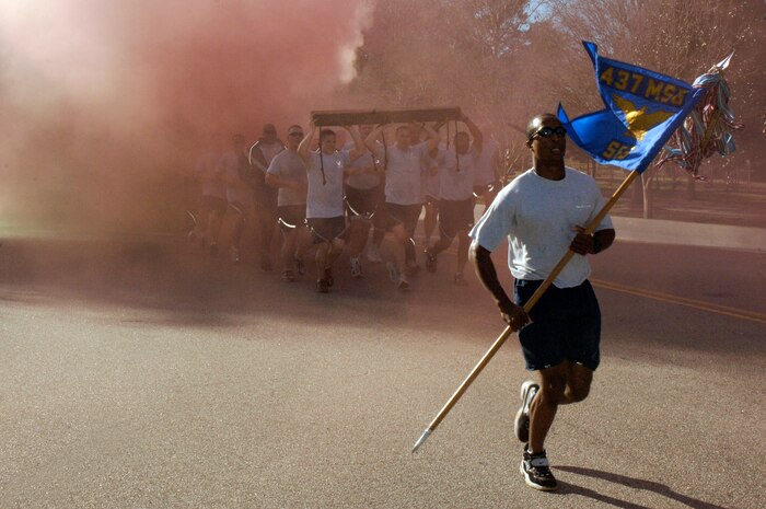 Security forces Airmen run in formation while competing for the spirit award during the Commander's Fitness Challenge on base Jan. 9. More than 400 Airmen from various squadrons came out to participate in the  5K run. (U.S. Air Force photo/Staff Sgt. Marie Cassetty)