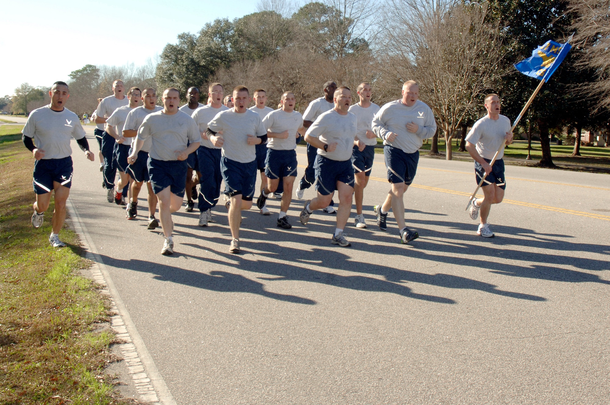 Airmen from the 437th Communications Squadron run in formation while competing for the spirit award during the Commander's Fitness Challenge on base Jan. 9. More than 400 Airmen from various squadrons came out to participate in the  5K run. (U.S. Air Force photo/Staff Sgt. Marie Cassetty)