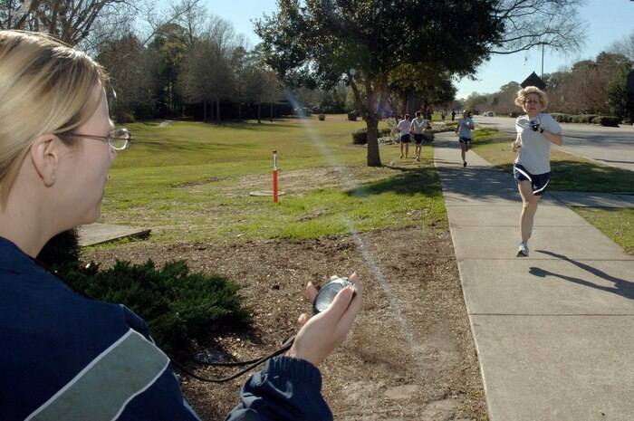 Dawn Gillen records the time as Michele Lobianco crosses the finish line during the Commander's Fitness Challenge 5,000-meter run here on base Jan. 9. More than 400 Airmen from various squadrons came out to participate in the  5K run. Lobianco was the first female to cross the finish line at 20:59 and is assigned to the 437th Operational Wing command post. Gillen is assigned to the 437th Force Support Squadron. (U.S. Air Force photo/Staff Sgt. Marie Cassetty)