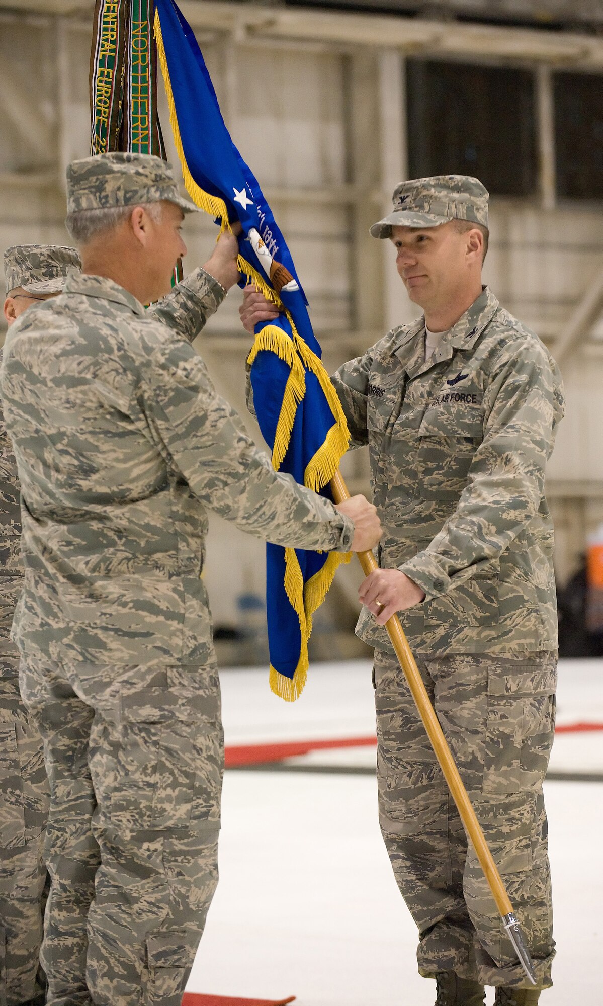 Col. Manson O. Morris, 436th Airlift wing commander, accepts the 436th AW guidon and command of the Eagle Wing from Maj. Gen. Winfield W. Scott III, 18th Air Force commander, during a change-of-command ceremony Jan. 9. Colonel Morris assumed command from Col. Steven B. Harrison, who will become the commander of the 89th Airlift Wing, Andrews Air Force Base, Md.  (U.S. Air Force photo/Jason Minto)