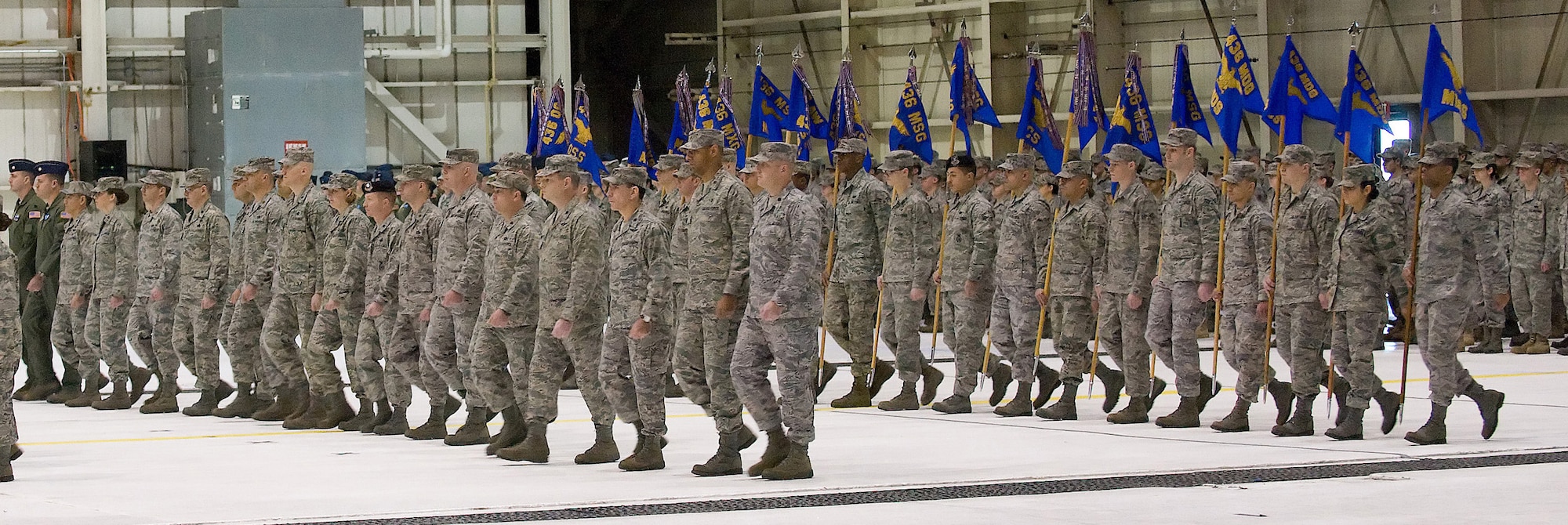 Squadron commanders and their guidon bearers from the 436th Airlift Wing march in formation as the Eagle Wing is presented to Col. Eric Wydra, 436th AW vice commander and commander of troops, during the change-of-command ceremony Jan. 9.  Col. Manson O. Morris assumed command of the Eagle Wing from Col. Steven B. Harrison. (U.S. Air Force photo/Jason Minto)