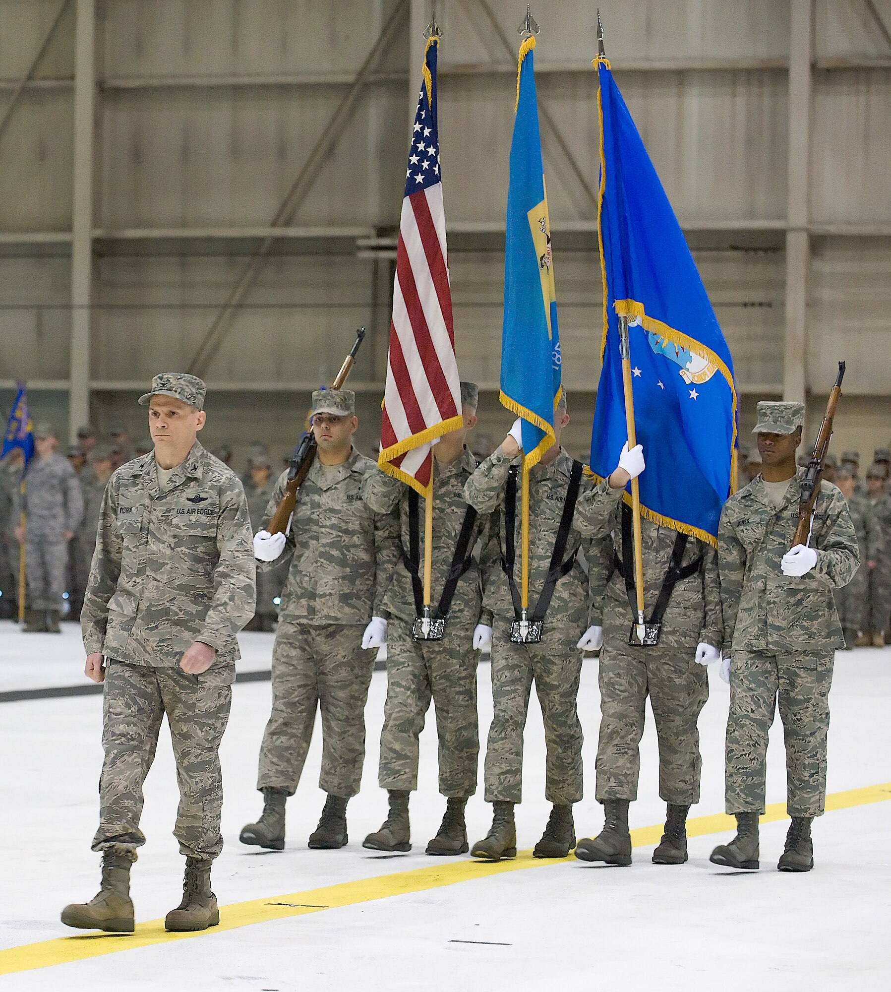 Col. Eric Wydra, 436th Airlift Wing vice commander, presents the colors to Maj. Gen. Winfield W. Scott III, during the change-of-command ceremony Jan. 9. Col. Manson O. Morris assumed command of the Eagle Wing from Col. Steven B. Harrison. (U.S. Air Force photo/Roland Balik)