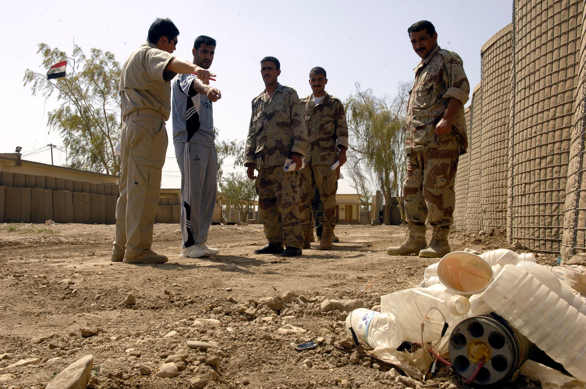 Officers with the Iraqi department of border enforcement team walk an improvised explosive device identification lane with their instructors with the U.S. border enforcement transition team at Camp Echo, Iraq. (U.S. Air Force photo/Airman 1st Class Matthew Plew) 
