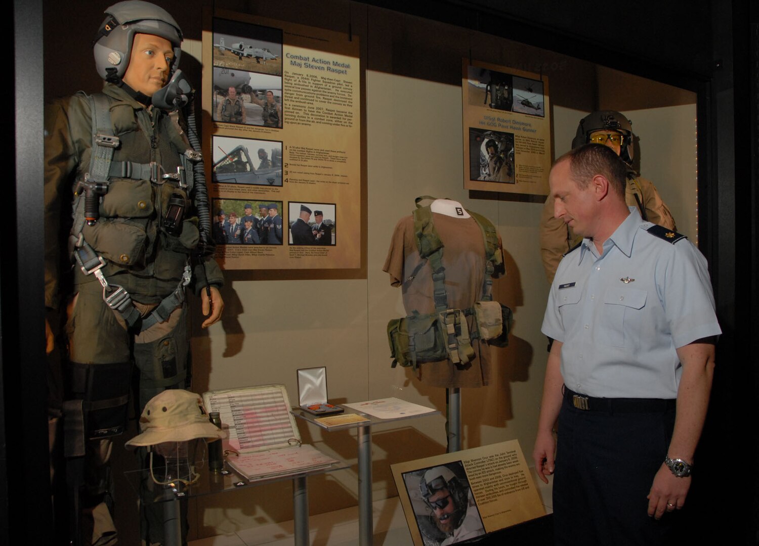DAYTON, Ohio -- Maj. Steve Raspet looks at the mannequin that represents him and some of the artifacts he donated as part of the new "Warrior Airmen" exhibit at the National Museum of the U.S. Air Force.  Maj. Raspet, a 354th Fighter Squadron A-10 pilot, was the first Airman to have the Combat Action Medal pinned on.  (U.S. Air Force Photo) 