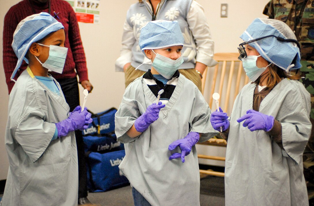 Dressed up as dentists, a group of children admire their new look during a health and hygiene presentation Feb. 12 at the Child Development Center at Langley Air Force Base, Va. The class given by the 1st Dental Squadron stressed teeth and mouth cleanliness as well as good eating habits. (U.S. Air Force photo/Airman Rebecca Montez)