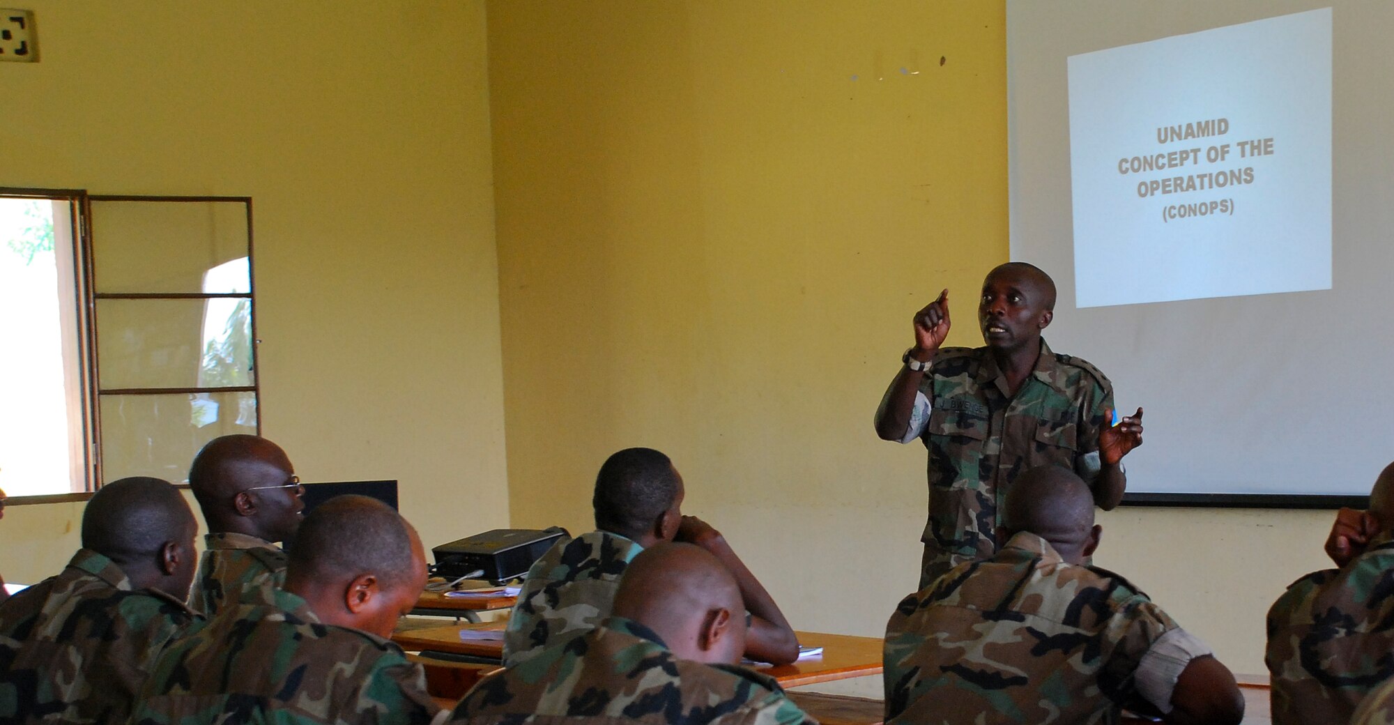 GAKO, Rwanda -- A Captain in the Rwanda Defense Forces gives an overview of the United Nations-Africa Union Mission in Darfur to peacekeeper trainees at the Rwandan Military Academy here Jan. 12, 2009. This training is conducted under the Africa Contingency Operations Training Assistance Program.  Here the entire curriculum is taught by Rwandan instructors.  Rwanda was the first county in Africa to be able to provide this training to its soldiers without U.S. instructors.  
ACOTA is a joint State Department and Department of Defense program.  About 12,000 Rwandan soldiers have been trained under the ACOTA program including the 3454 Rwandan peacekeepers currently deployed to Sudan.
(Photo by Staff Sergeant Samuel Bendet, U.S. Africa Command)