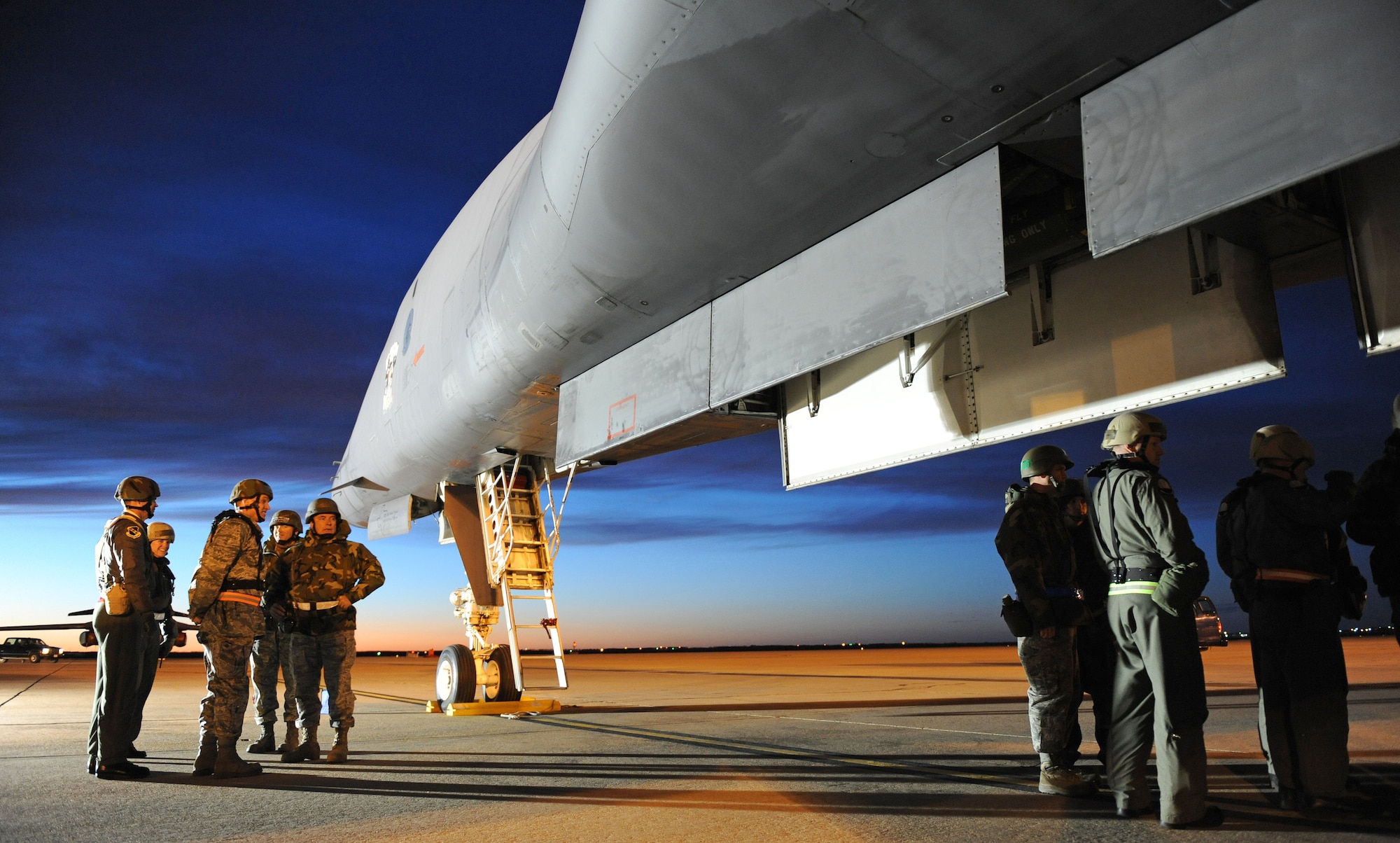 DYESS AIR FORCE BASE, Texas -- Col. Robert Gass (left/middle), 7th Bomb Wing commander, and other officers look over a B-1 lancer before it?s examined as night starts to fall during the Operational Readiness Inspection (ORI) here, 6 Jan.  The ORI looks over the base on its effectiveness in performing a wartime, contingency, force sustainment and operational mission.  (Air Force photo by Staff Sgt. Connor Estes) 