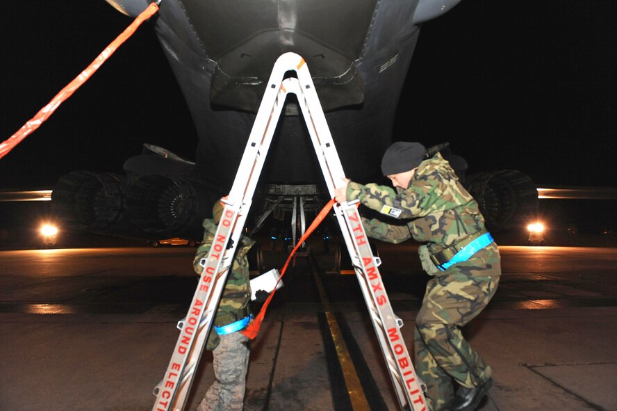 DYESS AIR FORCE BASE, Texas -- SrA Marjorie Carr, Weapons Loader for the 7th Aircraft Maintenance Squadron, climbs a ladder to remove the TDS (towed decoy system) safety pins in order to arm up the B-1 Lancer jet during the Operational Readiness Inspection (ORI) here, 6 Jan.  The ORI looks over the base on its effectiveness in performing a wartime, contingency, force sustainment and operational mission.  (Air Force photo by Staff Sgt. Connor Estes) 