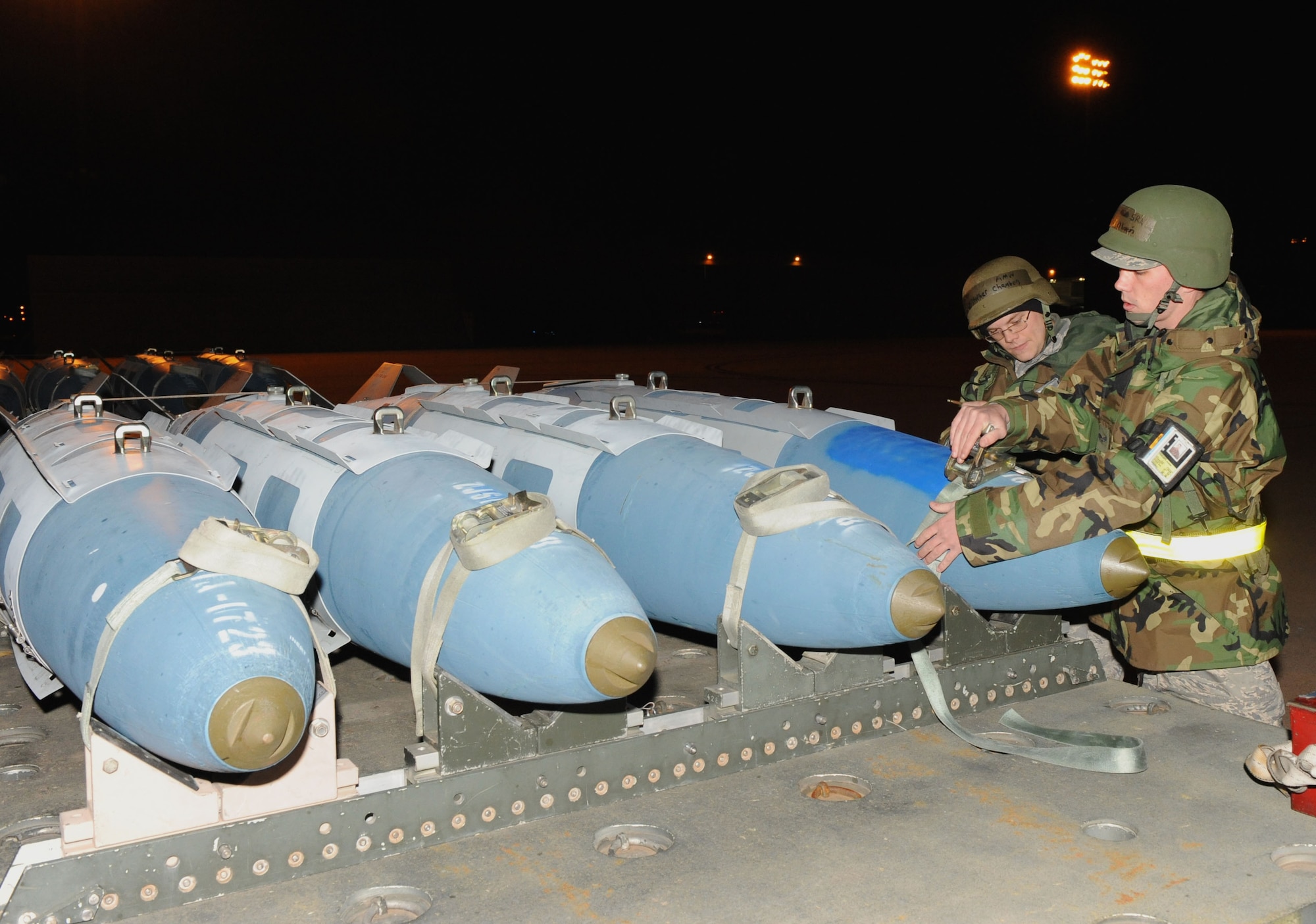 DYESS AIR FORCE BASE, Texas -- SrA Christopher Chambers (left) and A1C Charles Oliveri, 7th Munitions Squadron, perform a weapons check during the Operational Readiness Inspection (ORI) here, 6 Jan.  The ORI looks over the base on its effectiveness in performing a wartime, contingency, force sustainment and operational mission.  (Air Force photo by Staff Sgt. Connor Estes) 
